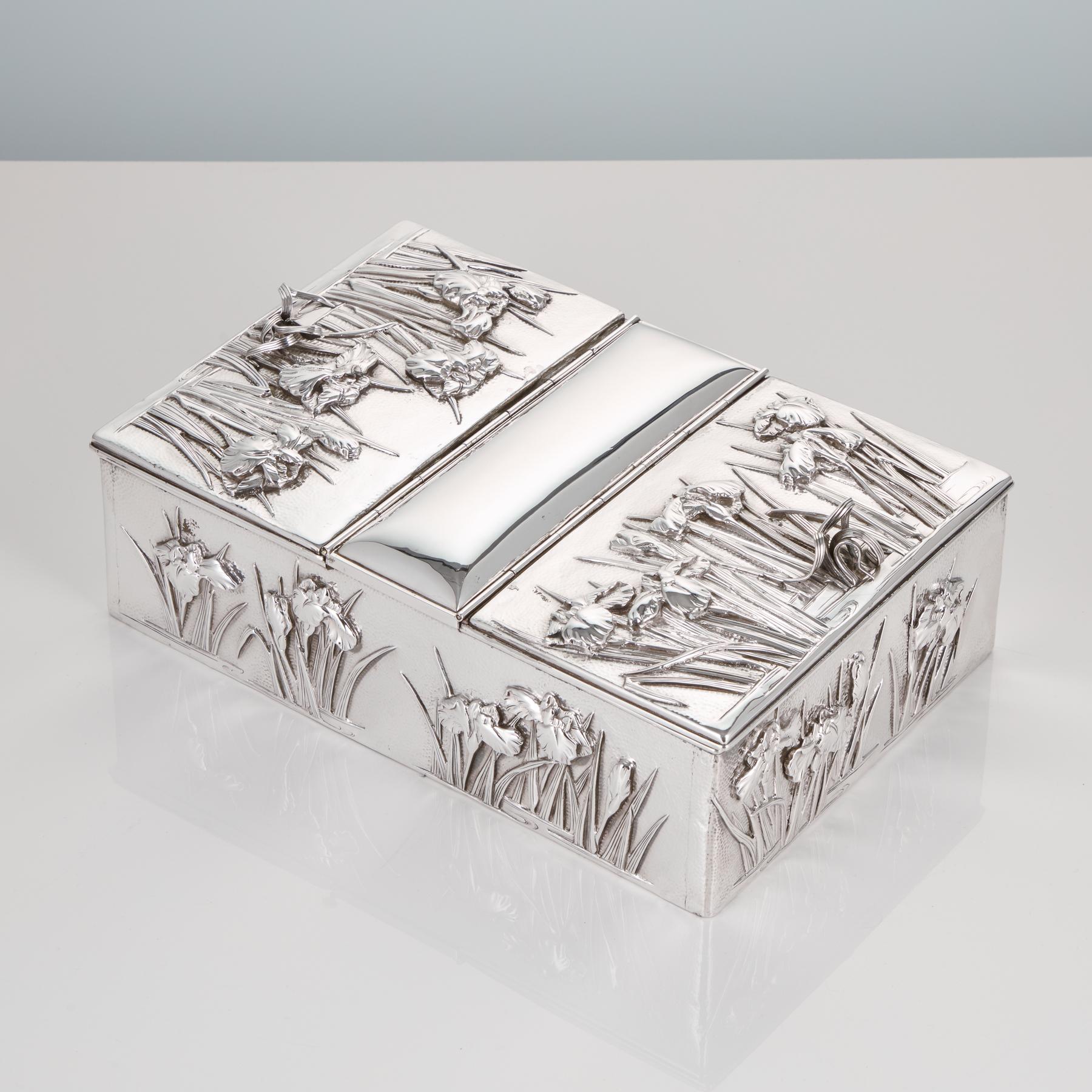 Antique early 20th century Japanese silver box with overlaid iris decoration from the Muji period, circa 1910
A decorative Japanese silver box with 2 compartments.
The hammered surface and the richly overlaid Iris flower decoration really enhance
