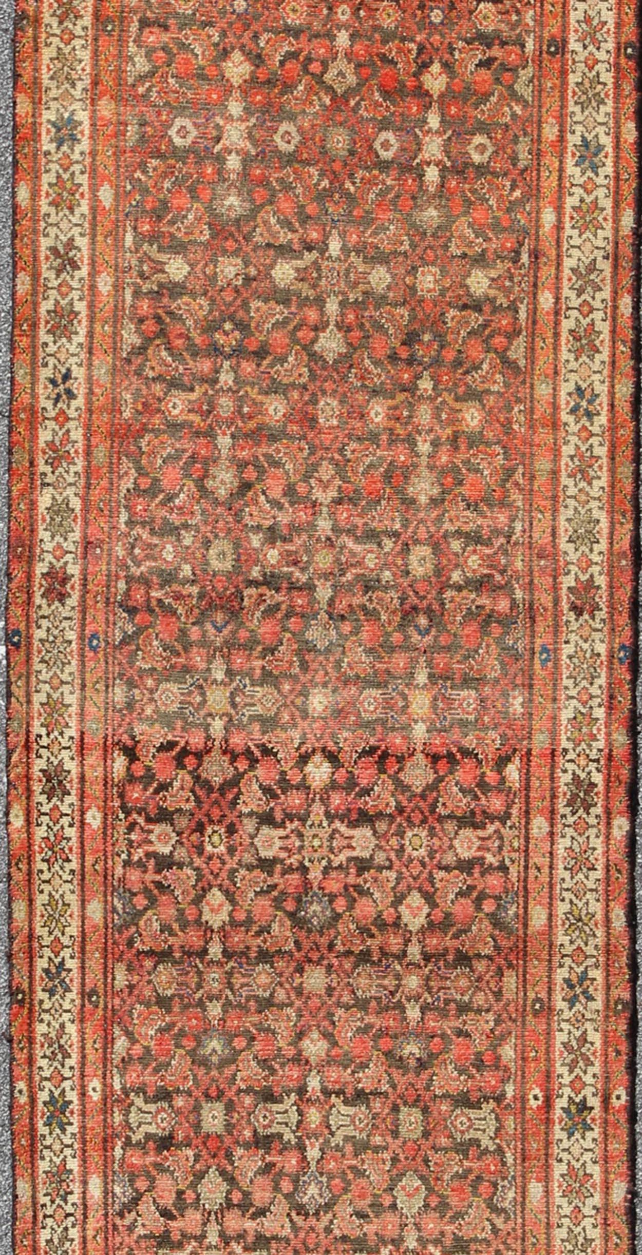 Malayer antique Persian runner H-711-21, kwarugs. This antique Malayer runner (circa 1900) bears a beautiful, all-over sub geometric design paired with a delightful palette of various shades of brown, charcoal, light green, ivory and orange. The