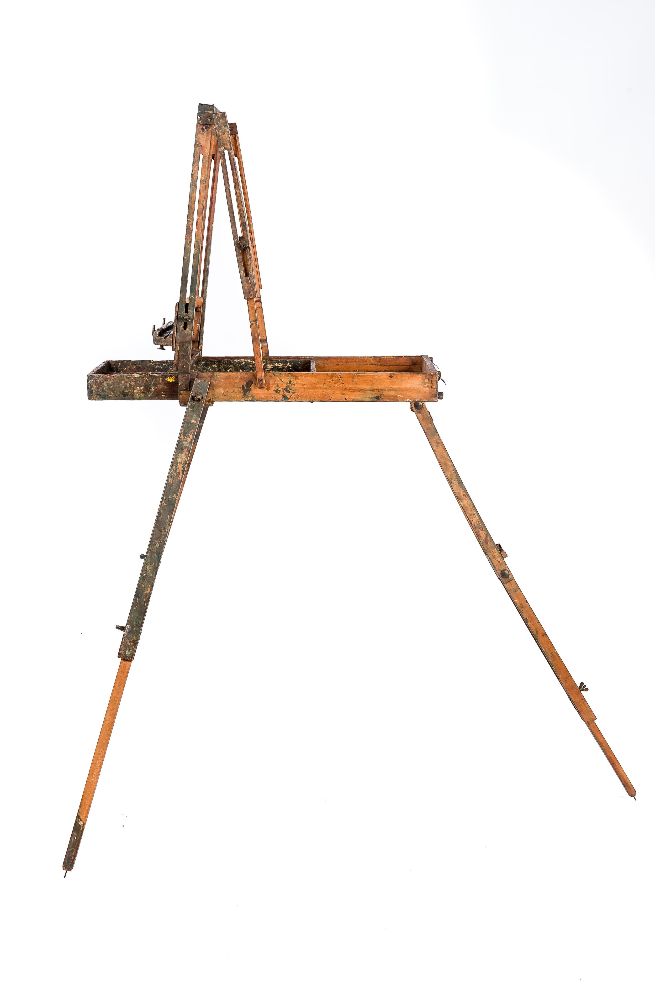 This elegant field easel was made in France in the early 1900s. The easel is fully adjustable in height and width and it also incorporates a drawer for keeping the paint. The whole piece folds down into an easy-to-carry package. The easel has been