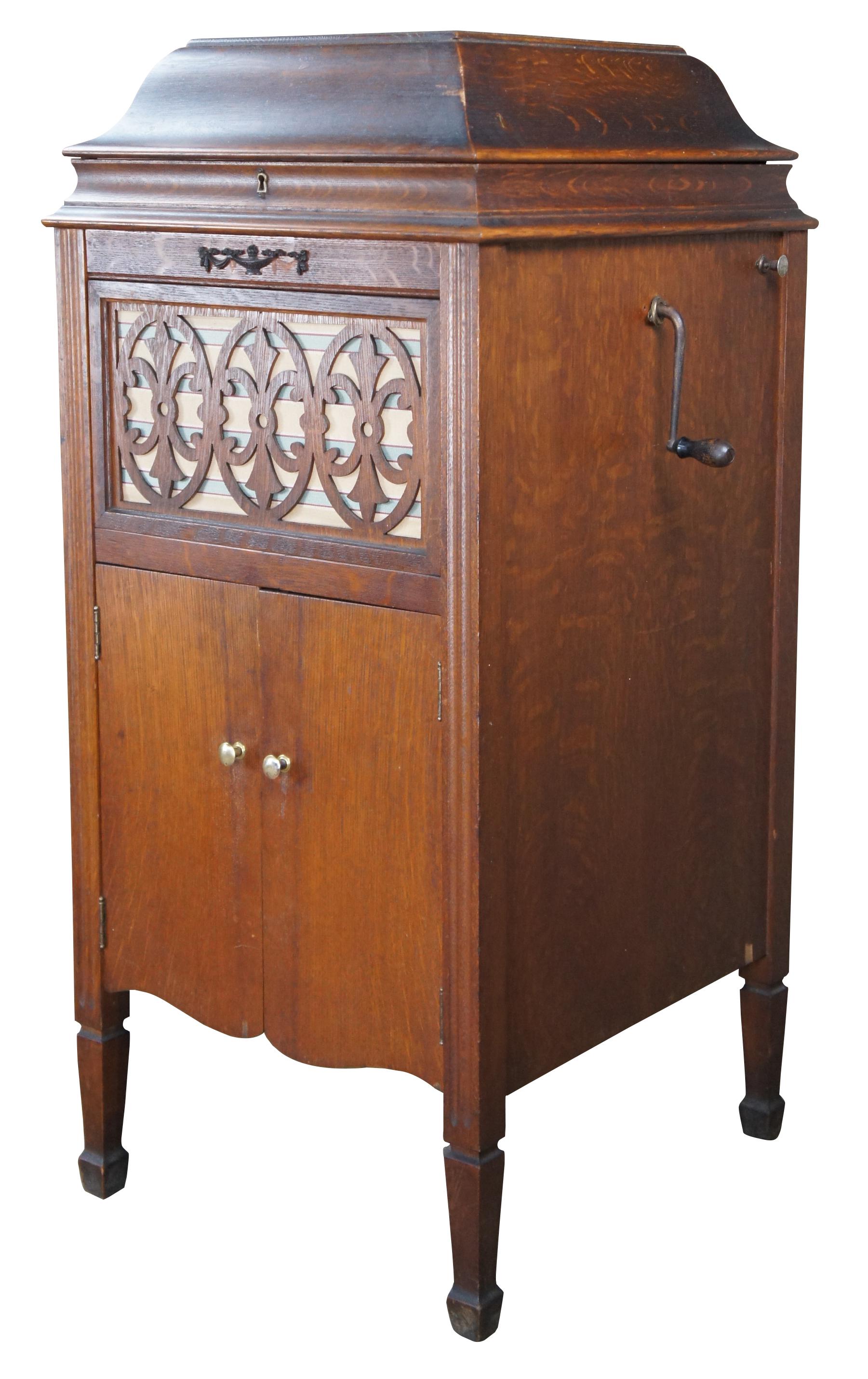 Antique Sears and Roebuck Silvertone Phonograph. Finished in oak with a quartersawn case. Features a nice cut geometric medallion over the speaker and lower storage below.  Model XIII Circa 1918.

The Silvertone logo features this little sprite
