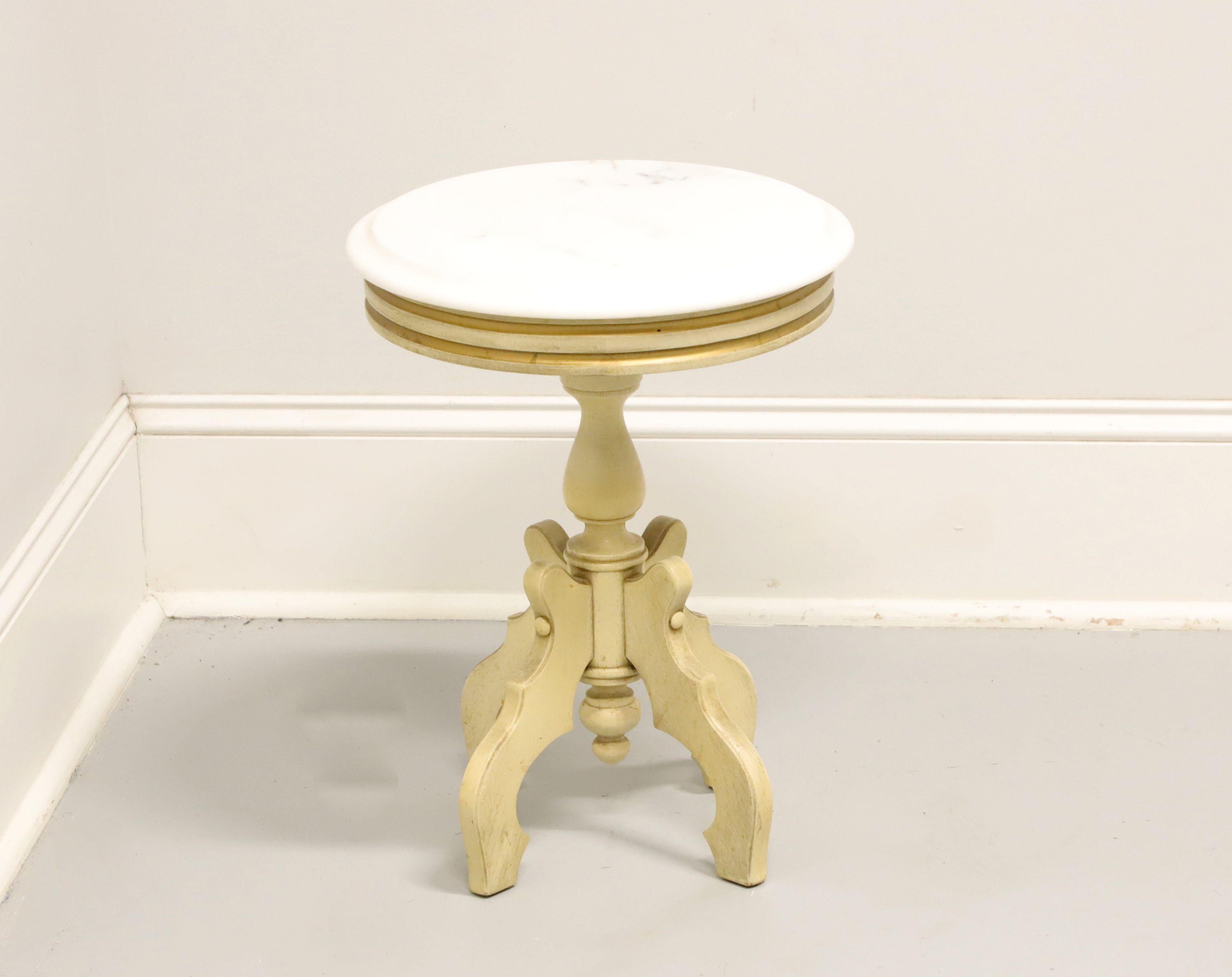 An antique Victorian style plant stand or side table, unbranded. Solid hardwood with slightly distressed, painted finish, round Italian marble bevel edge top, turned pedestal base, decorative reverse finial at bottom, and four carved curved legs.