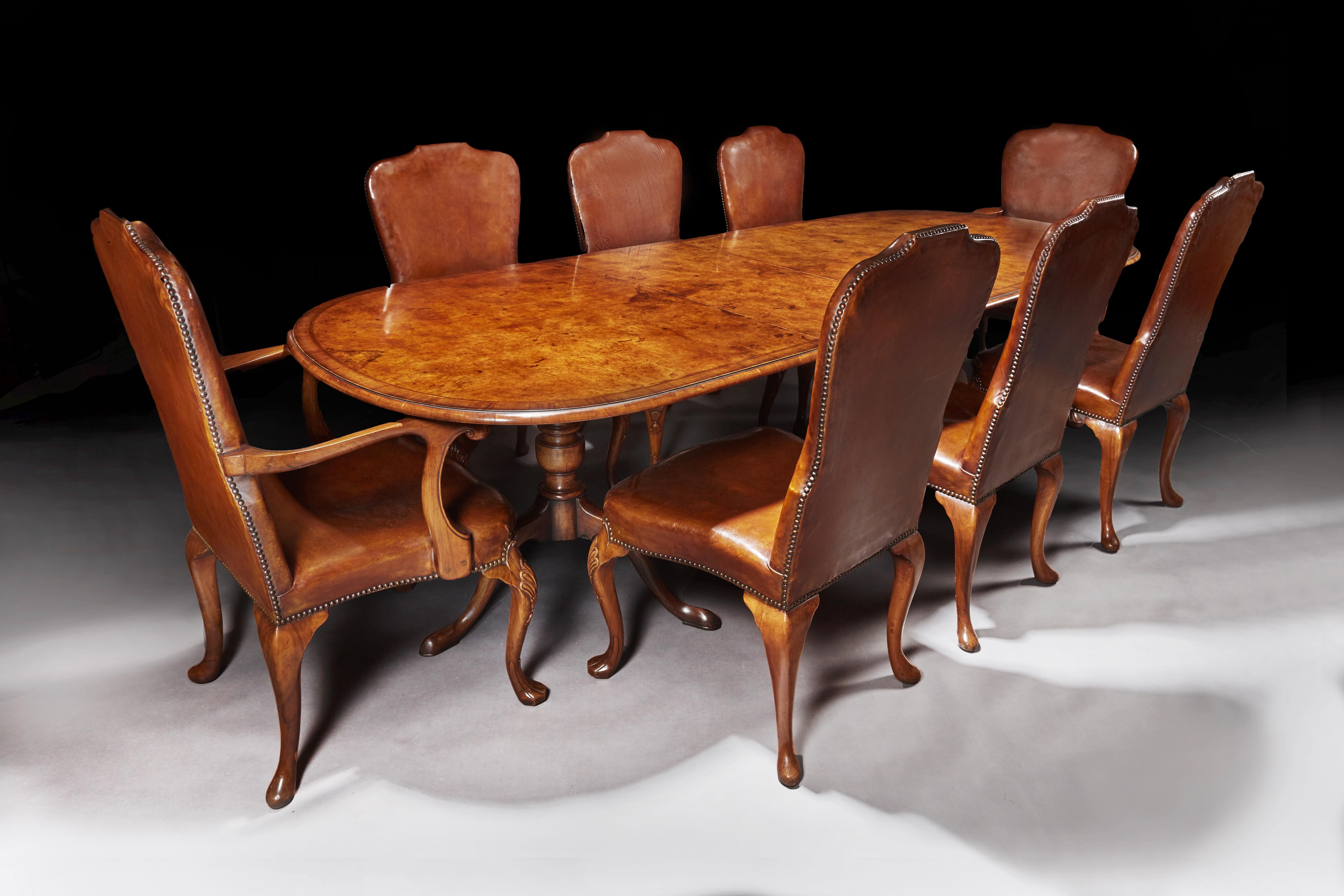 Antique early 20th century walnut dining table set with 8 leather chairs

A very good quality antique early 20th century dining set comprising of an burr walnut extending pedestal dining circa 1920-1930 and a set of 8 (6&2) walnut leather