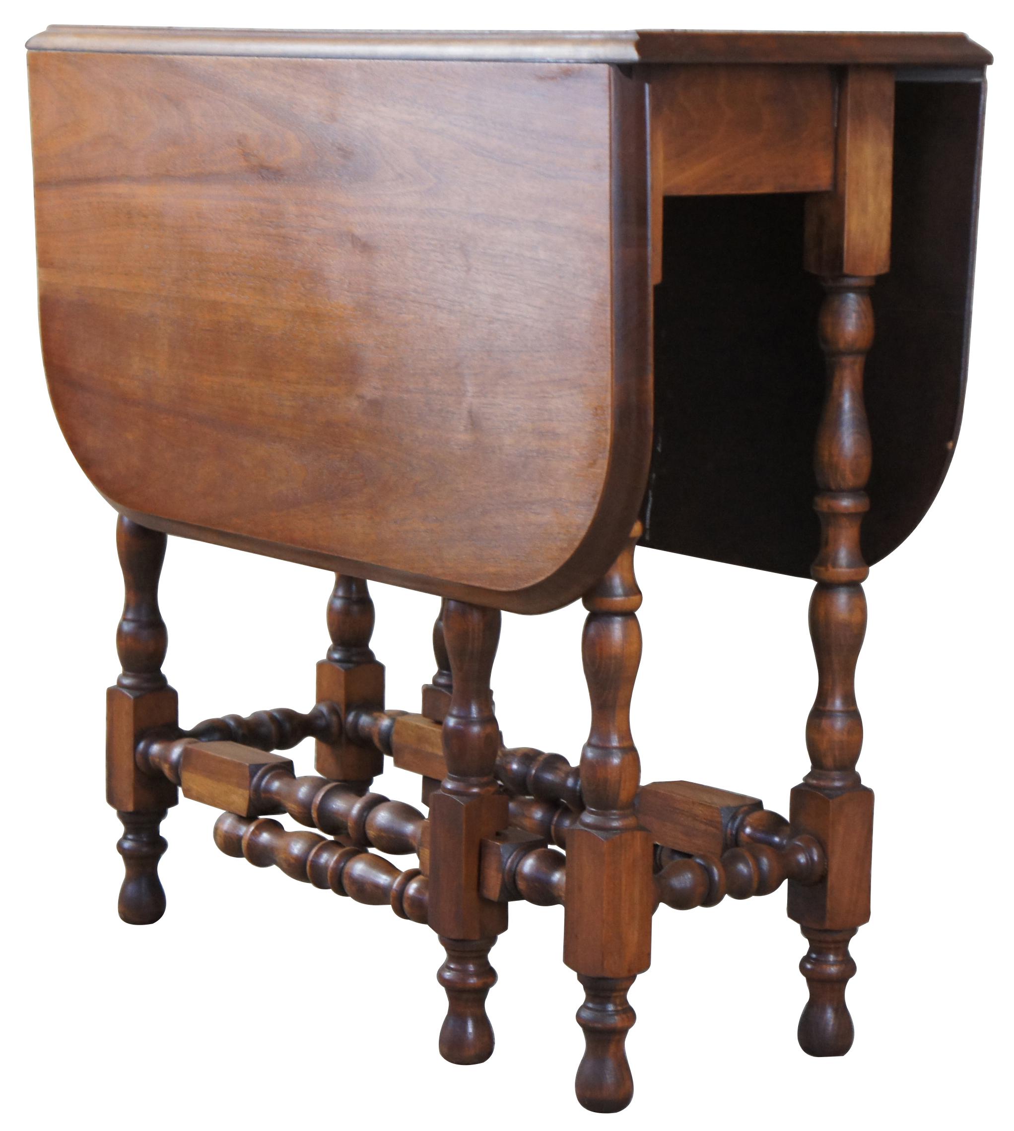 Early 20th century solid walnut drop leaf or gateleg table with drawer. Features an ogee edge and turned supports in William & Mary style.

Leaves add 15.5
