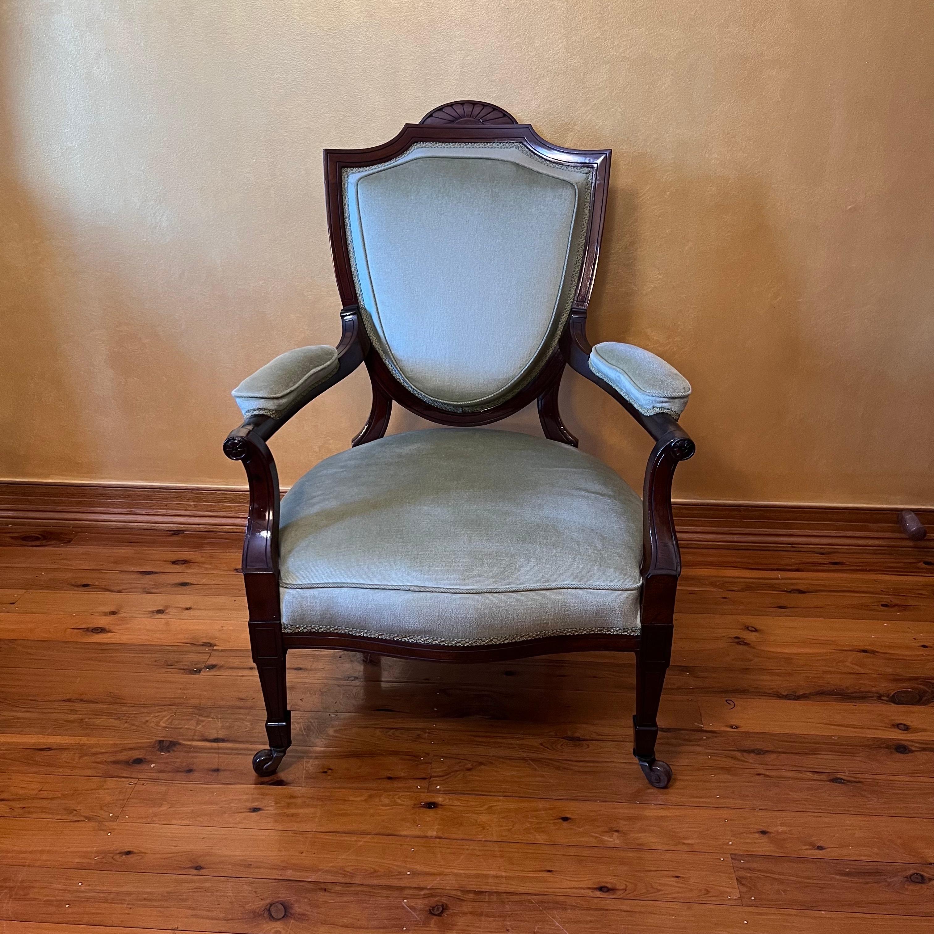 Two armchairs one larger and one smaller with two matching armless chairs, armchairs have a padded seat and pack with armrest both come with castors, armless have carved back detail with padded green velvet seats

Circa: Early20th Century