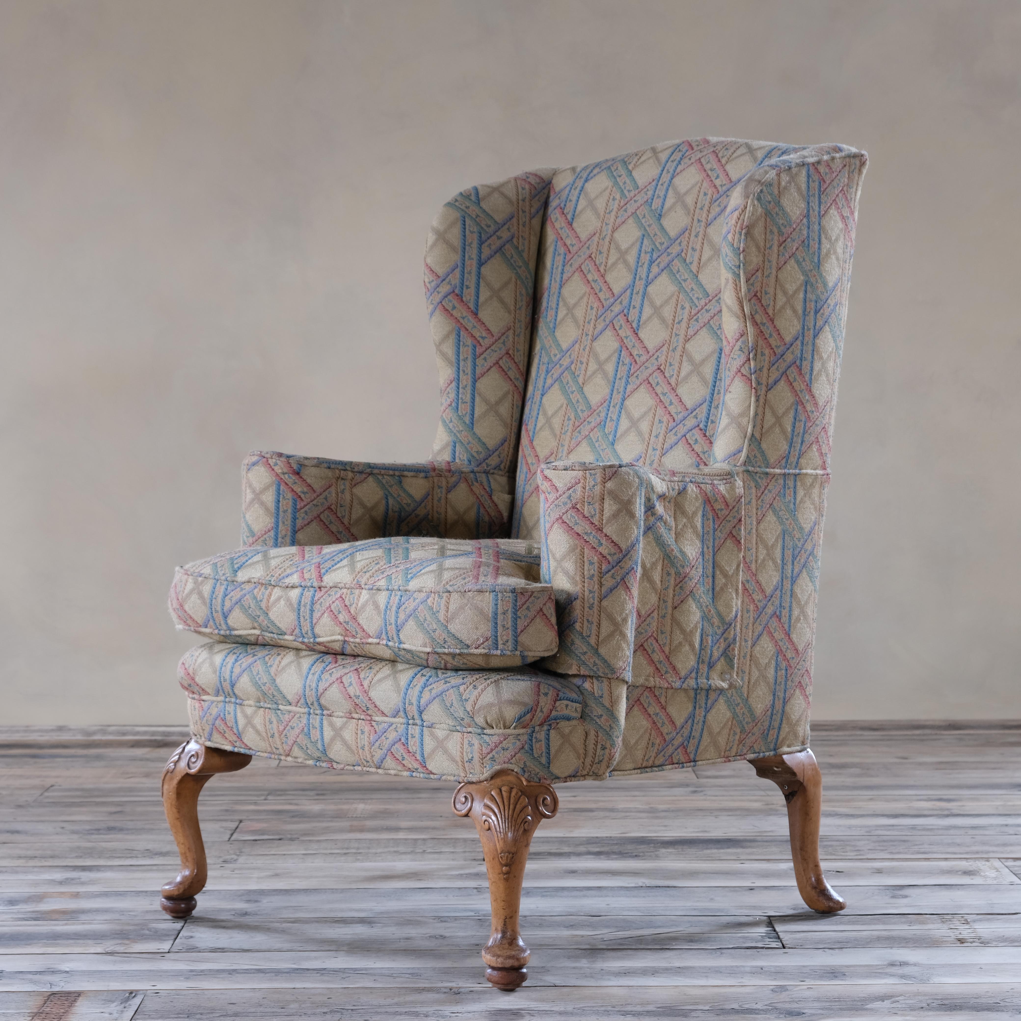A very attractive George III style wingback armchair raised on 4 cabriolet legs and upholstered in a nice tapestry type fabric. In good order throughout and does not require upholstery as its in very good clean condition and with fitted arm caps.
