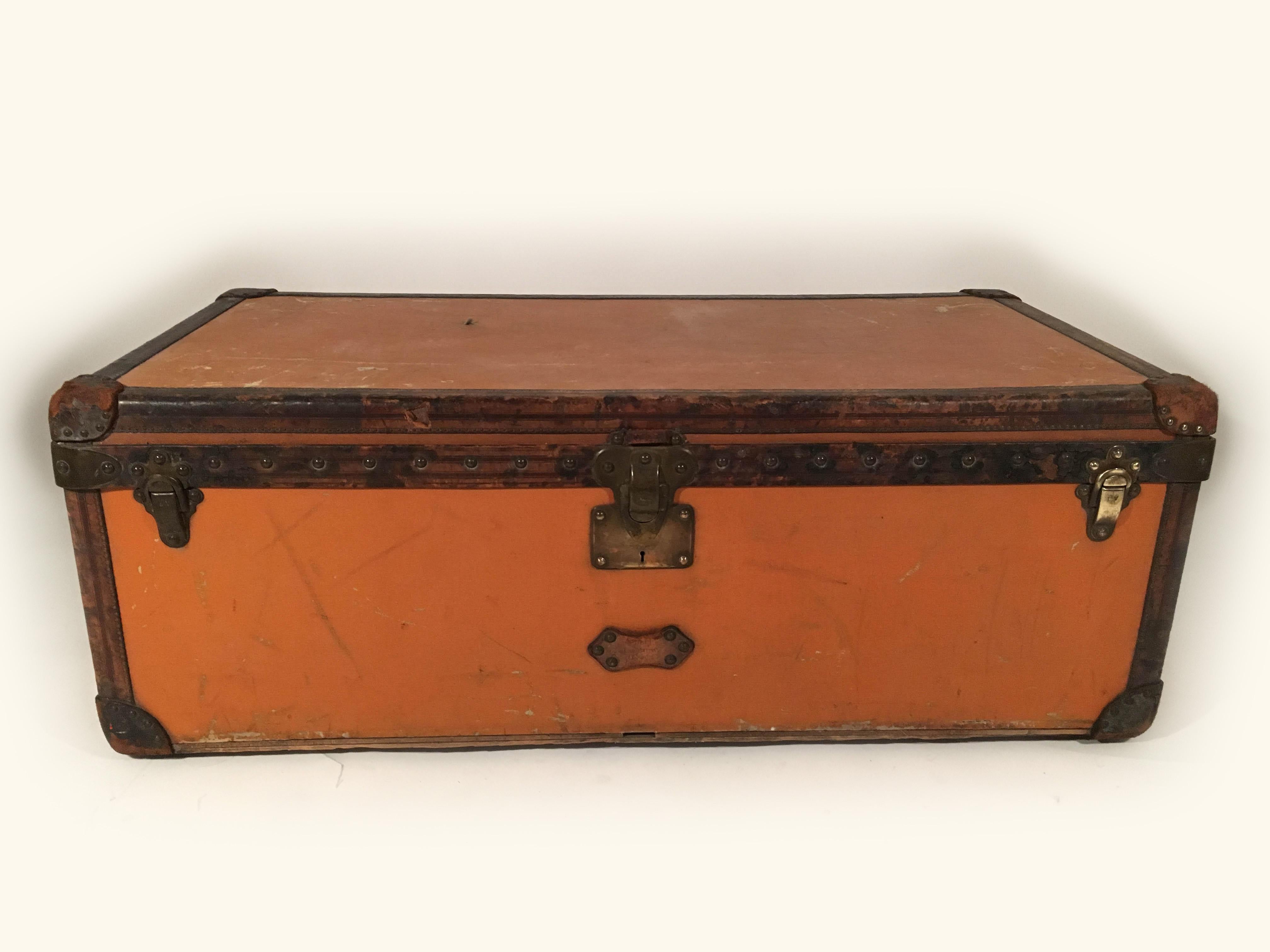 Large antique early 20th century superb Louis Vuitton malle cabine trunk. A large size in increasingly rare orange Vuittonite canvas, leather and brass bound, with wheels to the base and leather handles to either end, interior lined with cream