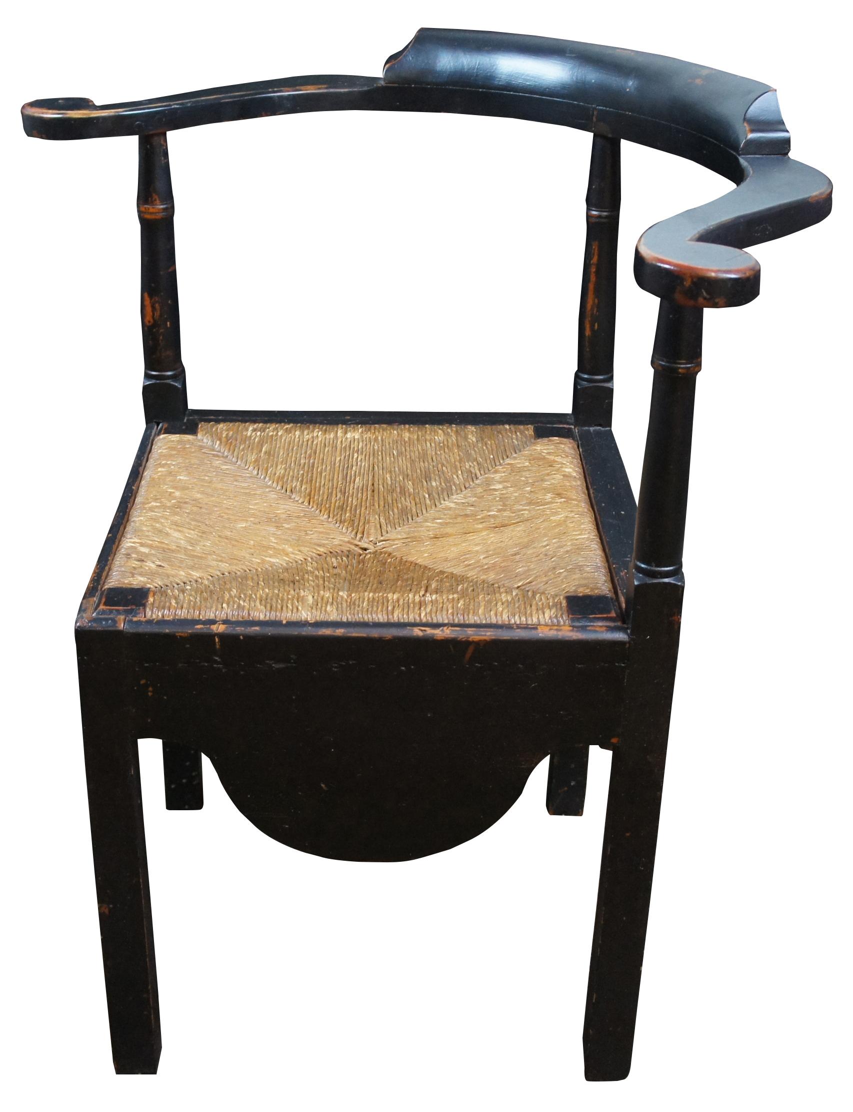 Antique Early American corner chair. Features rush seat and a curved crest with molding, finished in black with naturally distressed finish.

Seat corner to corner – 22.25”.