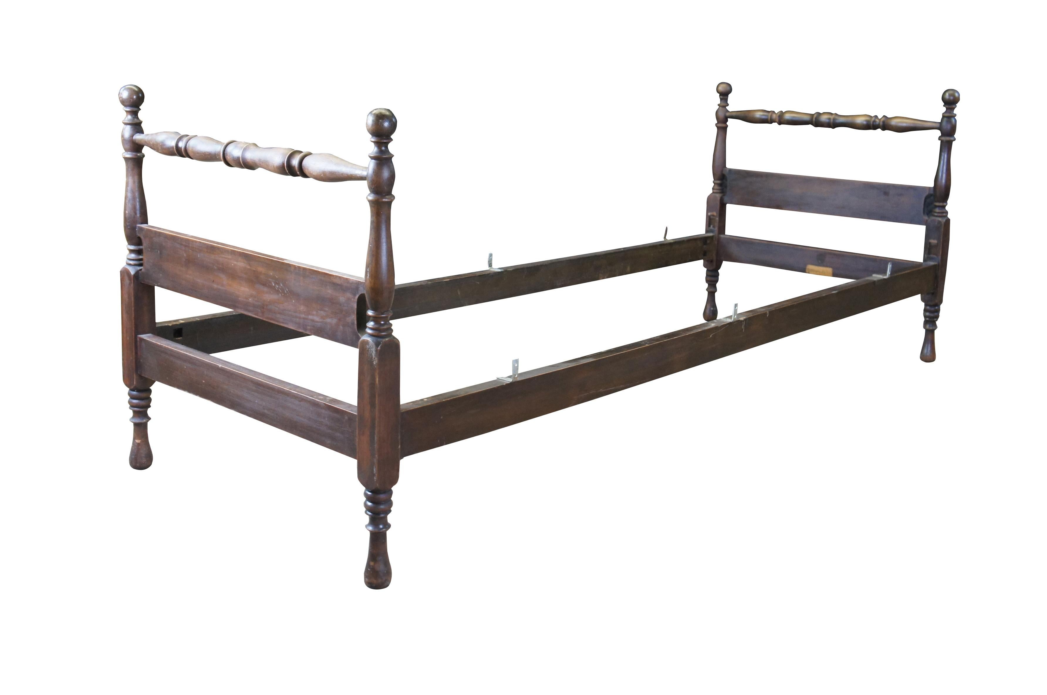 An antique Early American style small single poster bed.  Features turned posts and toupie feet.

Dimensions:
30