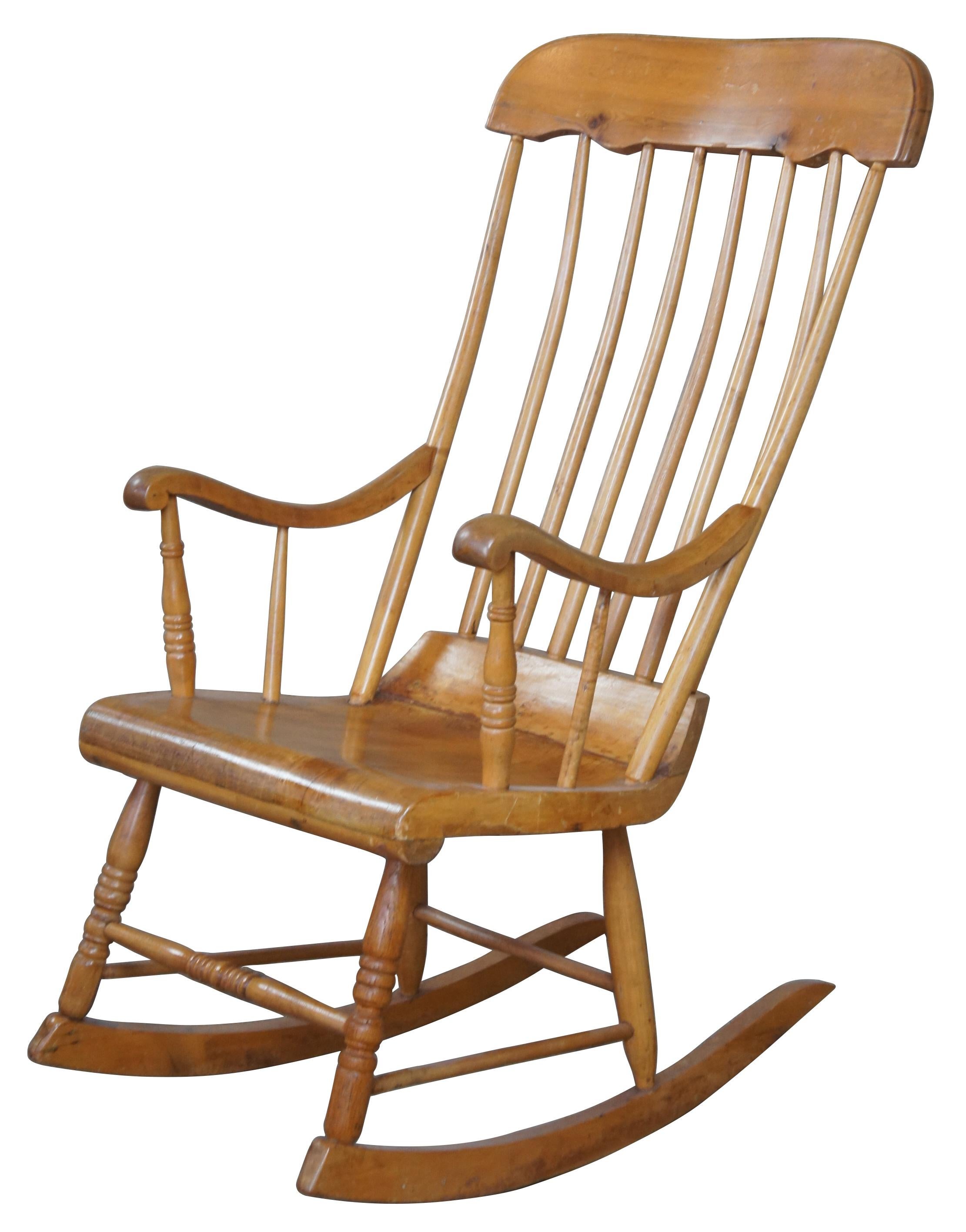 Antique artisinal or craftsman made Windsor style rocking chair. Made from pine with a spindle back and contoured arms.
  