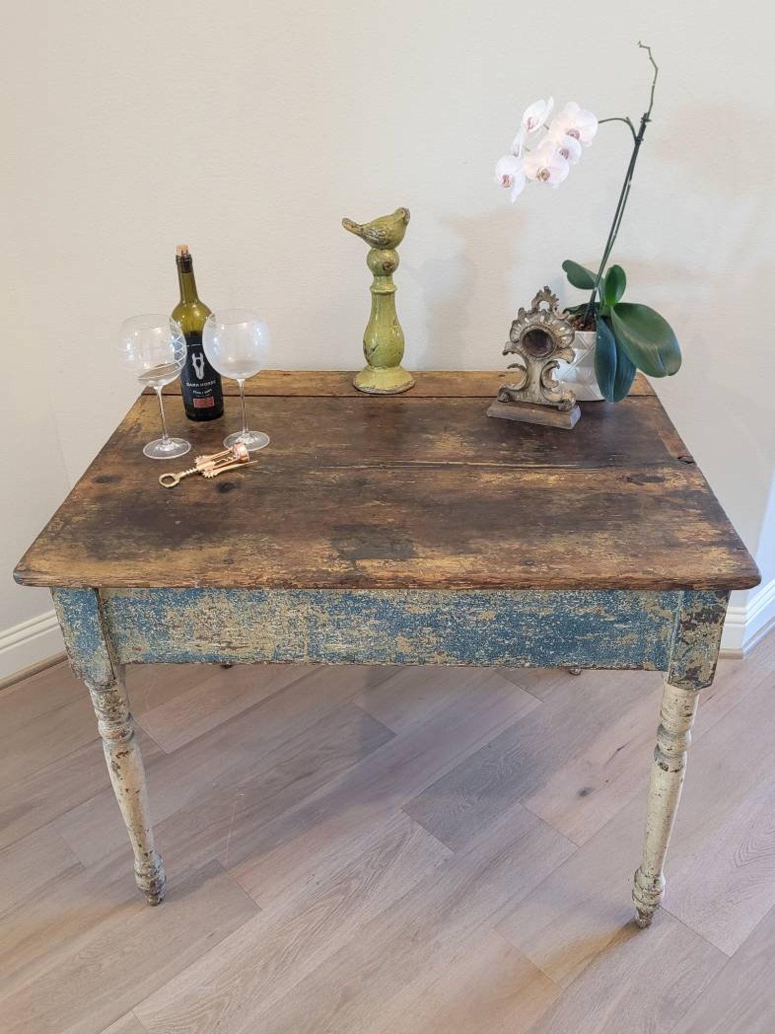 An antique, circa early 1800s, country American farmhouse painted pine table with nicely aged distressed patina. 

Featuring layers of the original remnants of blue and cream paint finish with heavily worn, warm, rustic, weathered, beautifully