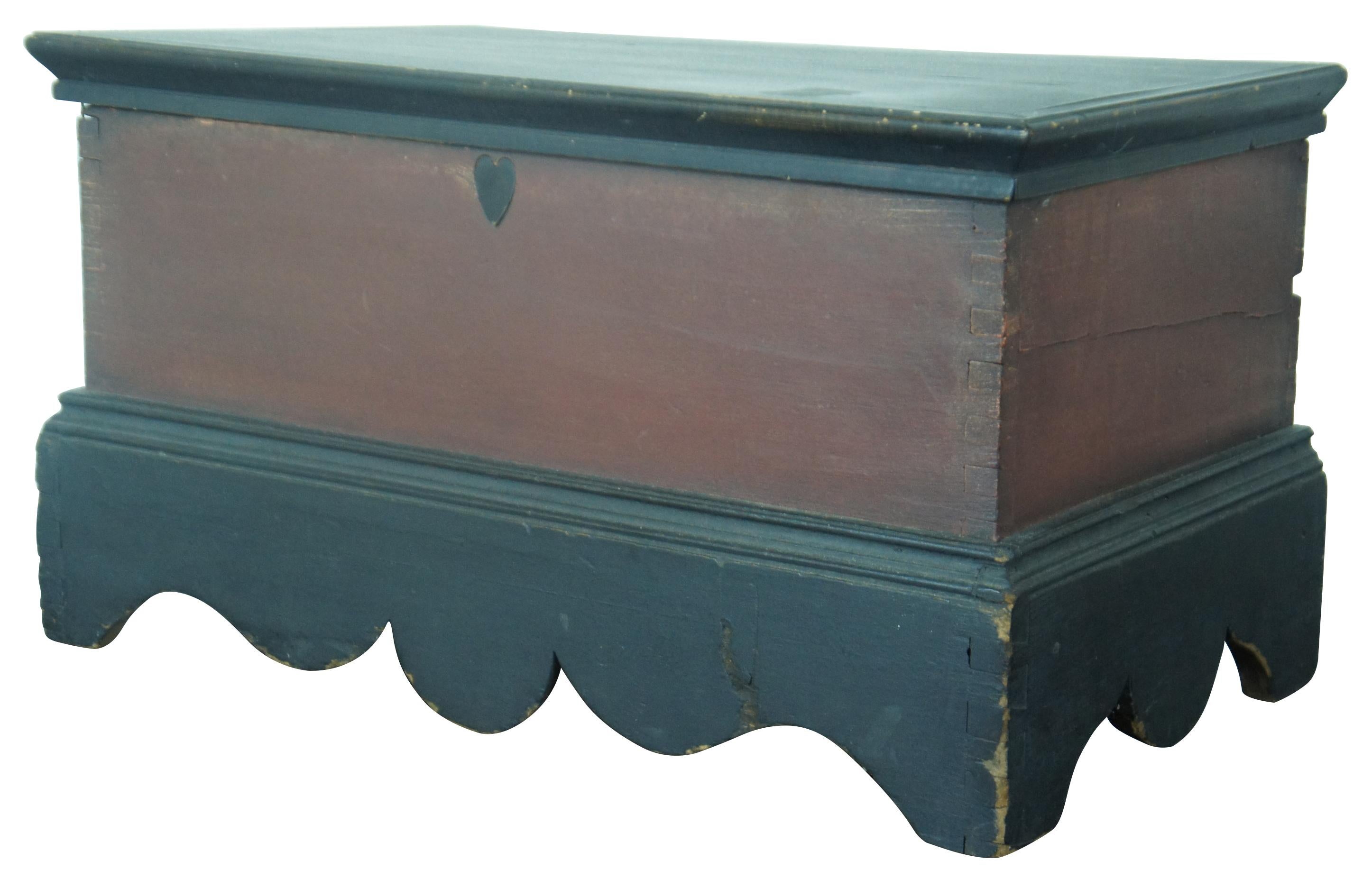 Antique 19th century dovetailed Salesman sample hope chest or toy storage trunk. Painted in red and black, with scalloped edging at the base and a heart where a lock would be.