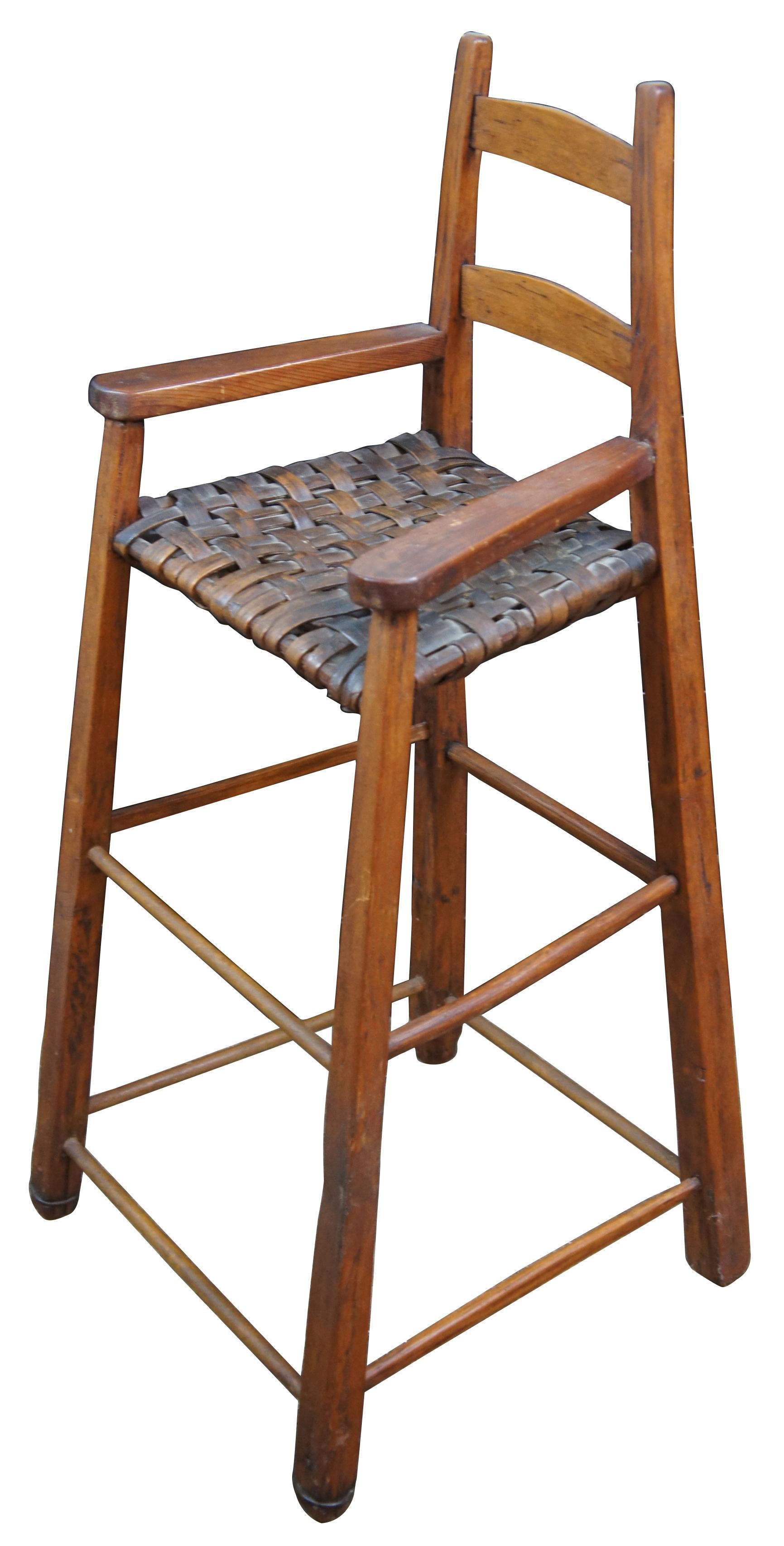 Antique handmade pine and rattan small childs or doll sized high chair with woven seat.
 
