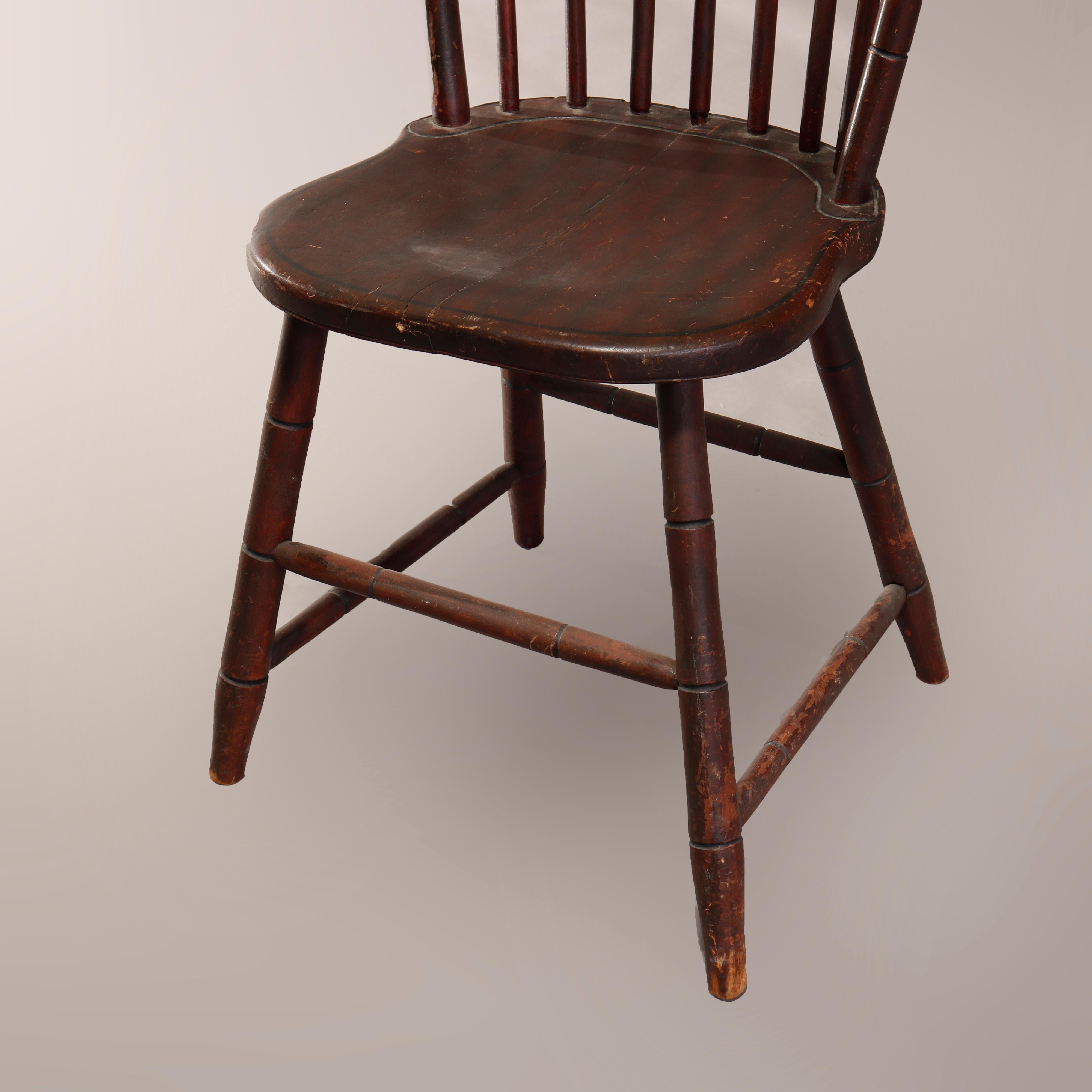 An antique early American Windsor side chair offers spindle back over seat with ebonized stenciled band, raised on turned legs, 19th century

Measures: 35
