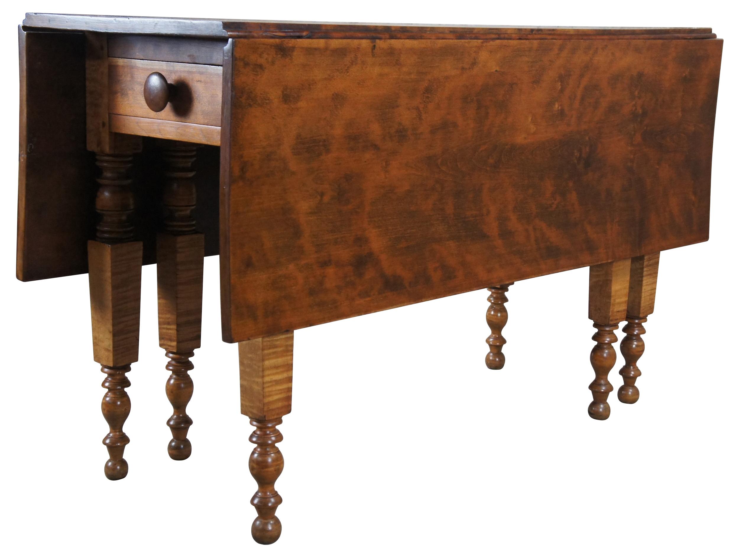 An impressive 19th century American gate leg table. Made from a beautiful curly (tiger) maple with hand turned legs and a drawer along the front. Great for use as a dining table or hallway console.

Measures: 48