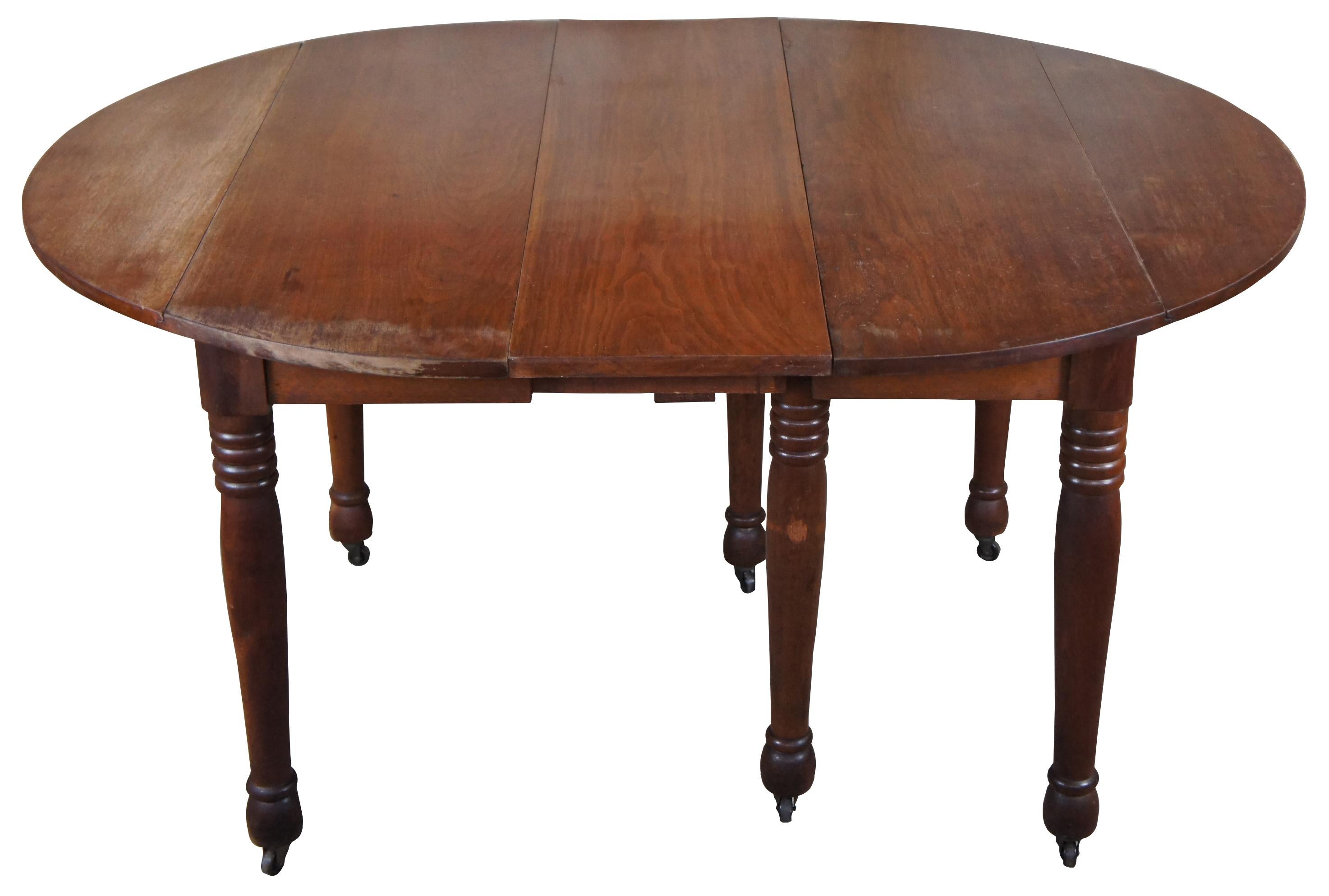 Antique walnut extendable dining or breakfast table featuring oval form with six legs and multiple extending leaves and drop leaves.

Measures: 39