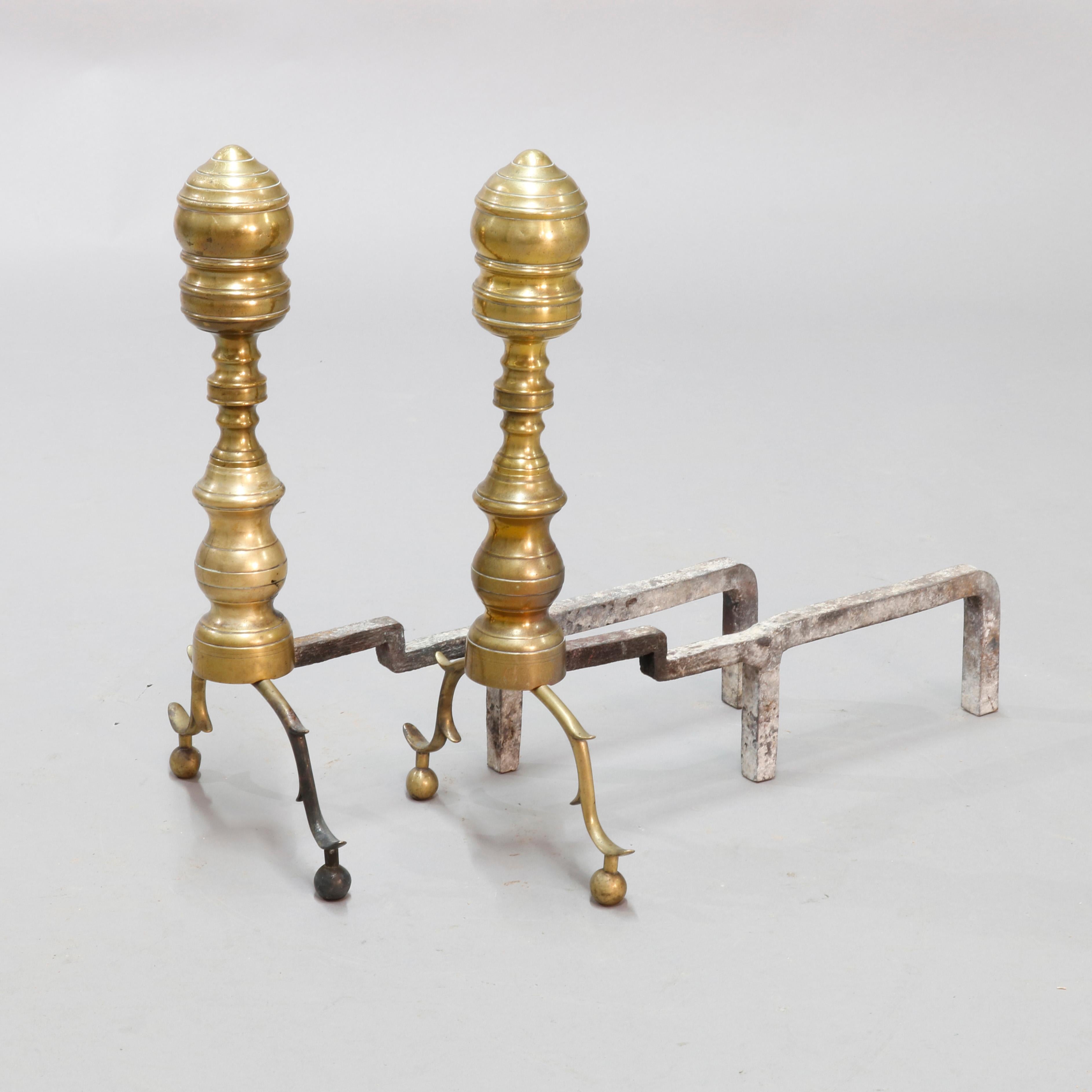 An antique set of early British Colonial andirons offer brass construction with beehive surmounting balustrade column and raised on foliate form cabriole legs terminating in ball feet, hand forged fire dogs, circa 1800.

Measures: 17.5