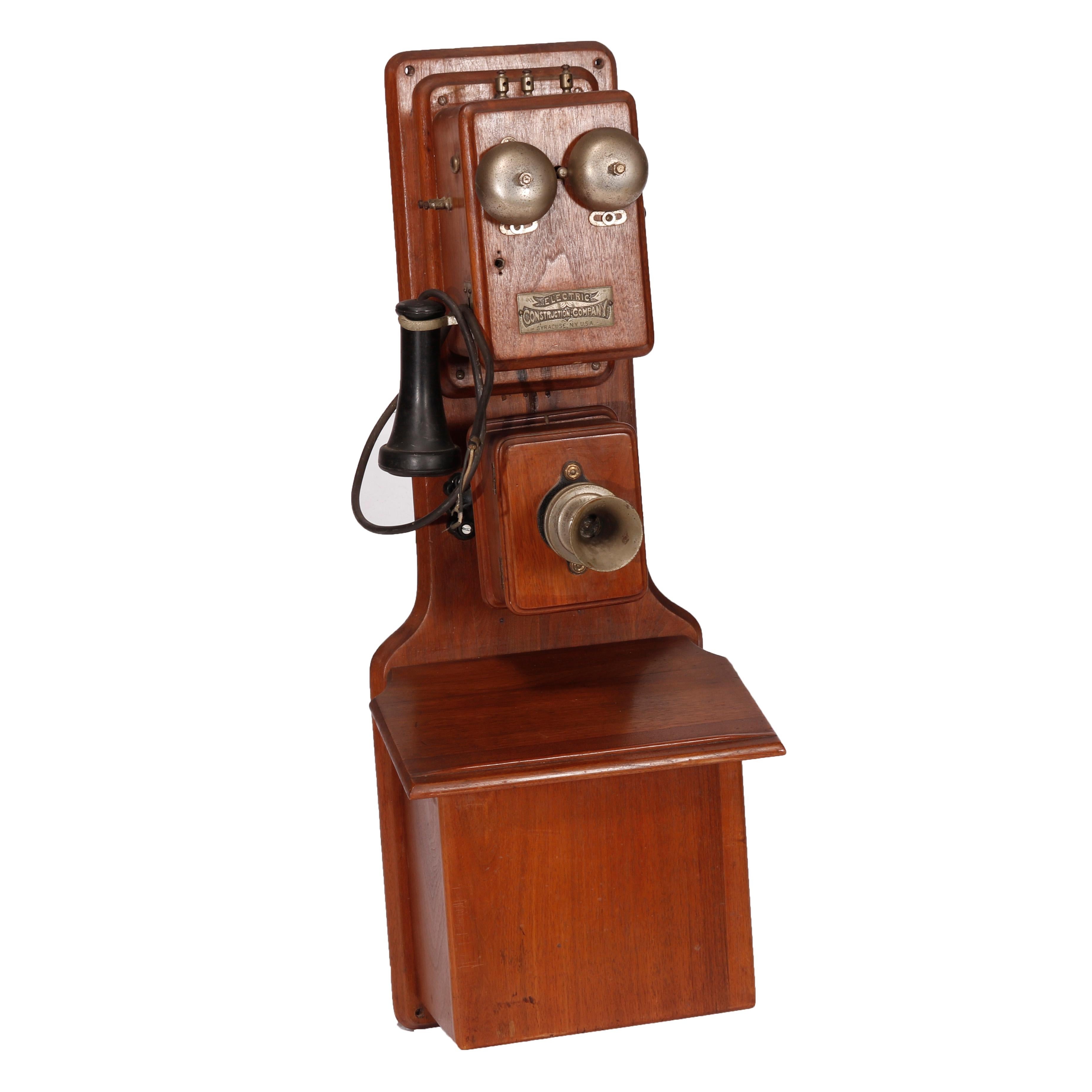 An antique early Electric Construction Co., Syracuse NY telephone offers walnut case and identifying plaque as photographed, 19th century

Measures - 32''h x 12''w x 8''d.
