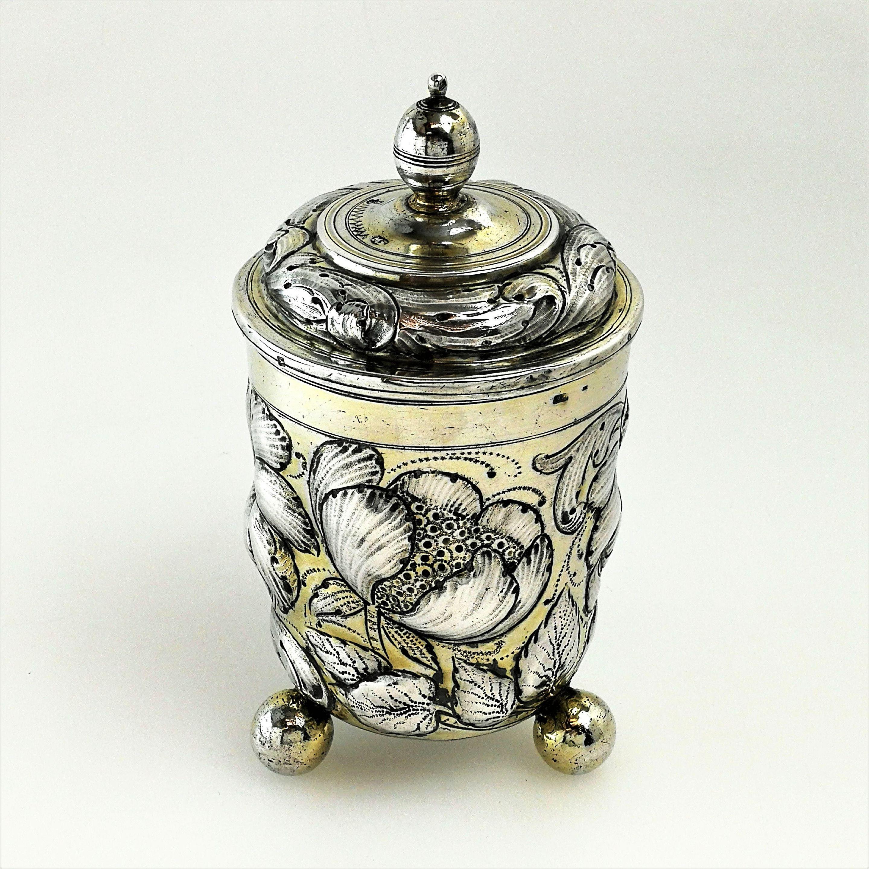 A gorgeous antique 17th century German silver cup and cover / lidded beaker. This Cup stands on three ball feet and is embellished with a rich chased floral design. The Cup jas a chased fitted lid. Both the beaker & lid are decorated with pale