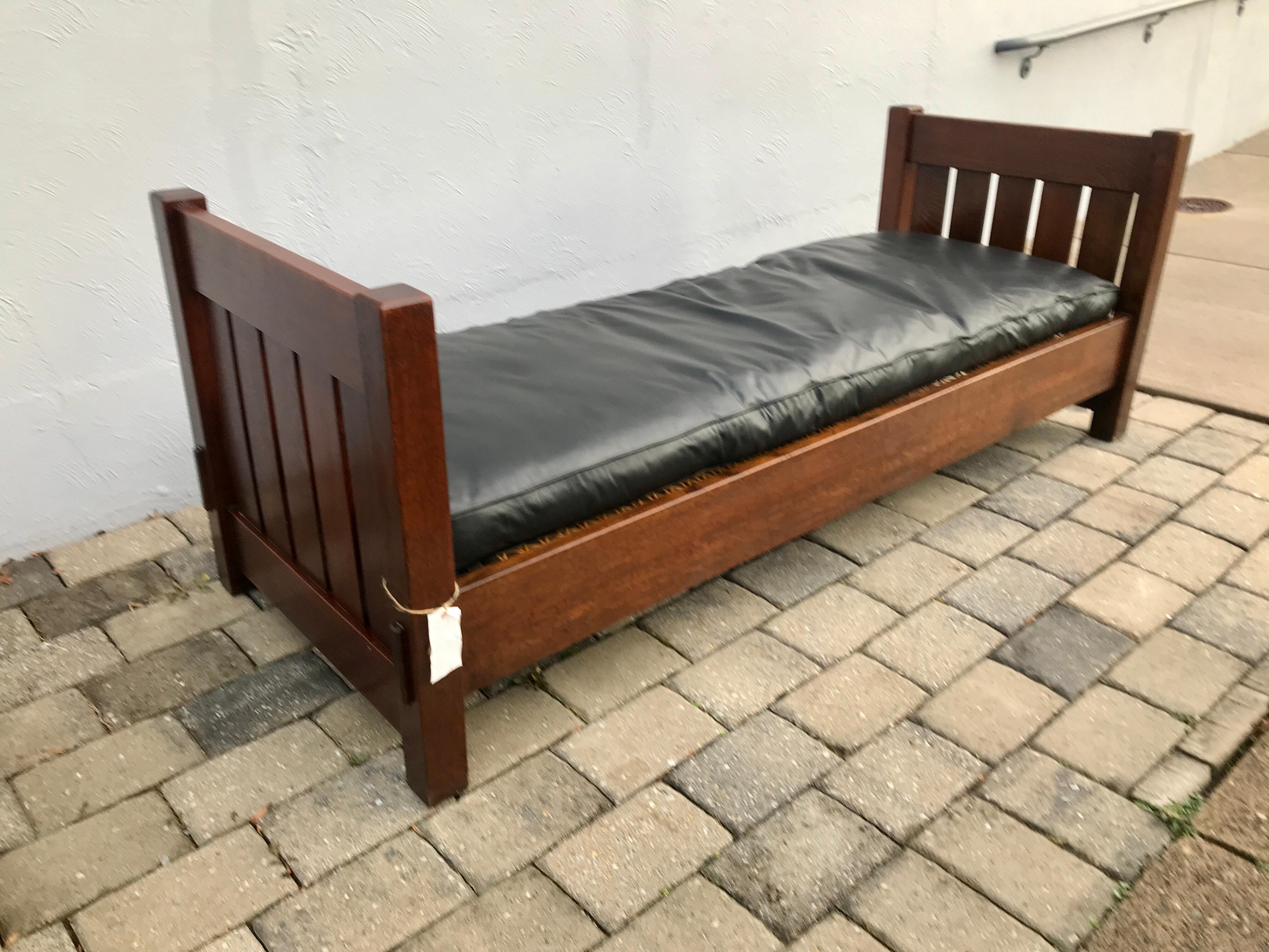 This is an extremely nice Gustav Stickley Lounge Model #216, made c 1902-04.  The Lounge is in pristine condition with a cane seat as pictured. It shows real through tenon construction on all legs and is pinned all around.  It has excellent original