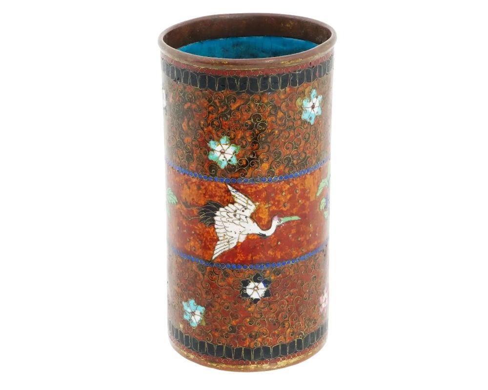 An antique Japanese early Meiji period cloisonne brush pot, attributed to the master artisan Namikawa Yasuyuki. Adorned with meticulously crafted floral designs accentuated by fine beadwork, the pot is a visual masterpiece, reflecting vibrant colors