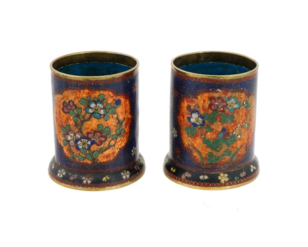 A pair of 19th century Japanese cloisonne brush pots with floral decoration, early Meiji period, circa 1880s. Attributed to Namikawa Yasuyuki, 1845 to 1927. Each of a cylindrical form, covered with dark cobalt blue enamel decorated with polychrome