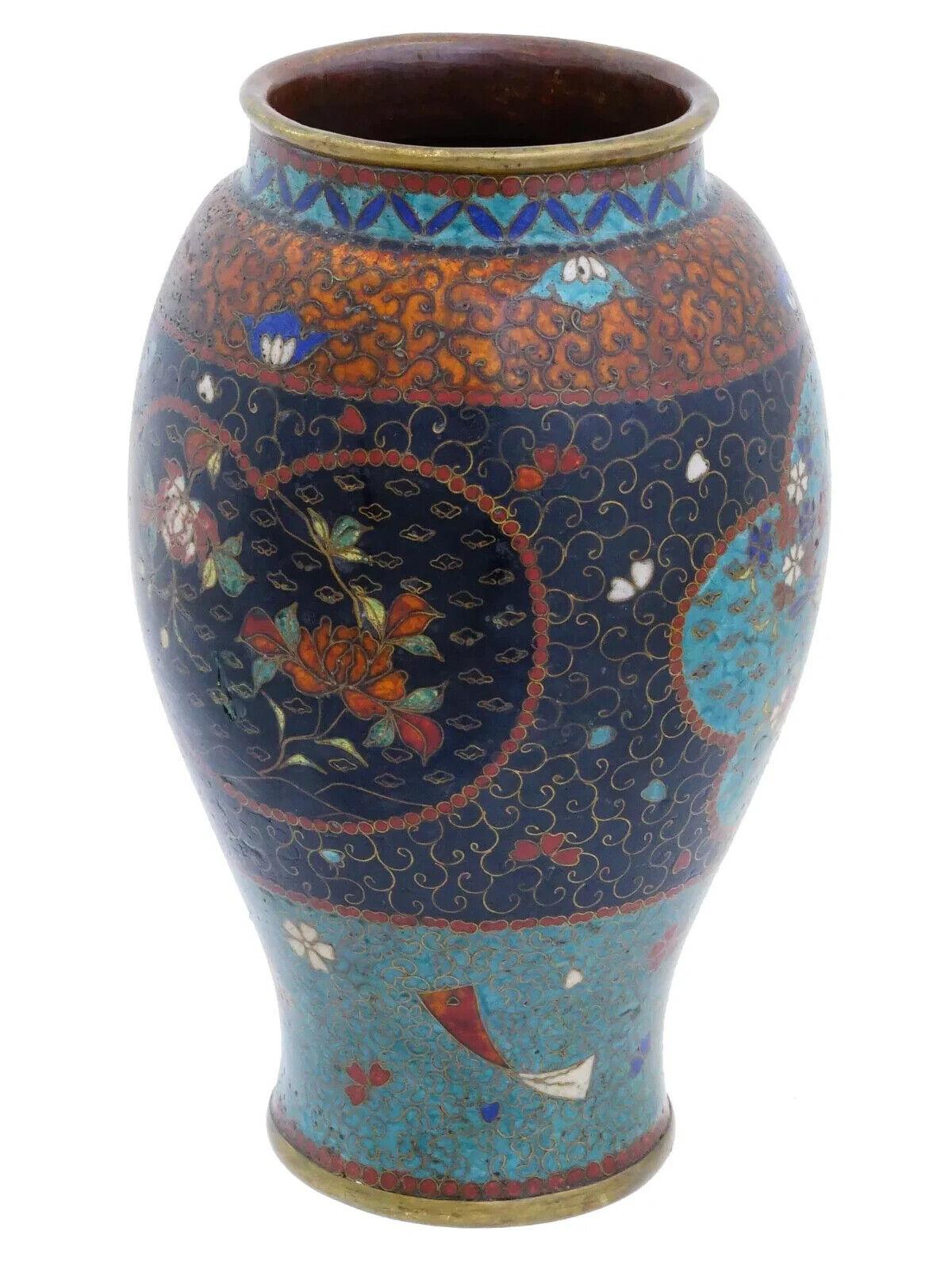 Un antico vaso giapponese in smalto cloisonne del periodo Meiji. Vaso a forma di balaustro decorato con una fascia di colore arancione con elementi vorticosi e floreali nella parte superiore, seguita da una fascia più ampia di colore blu scuro con