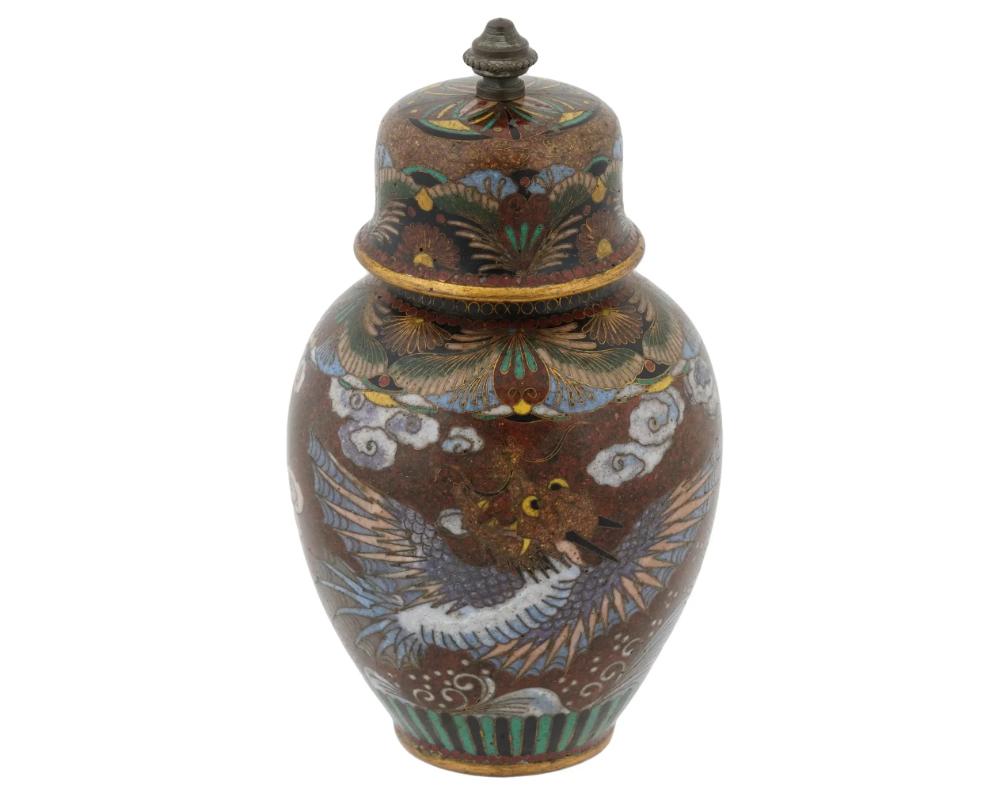 Antique Early Meiji Japanese Cloisonne Goldstone Enamel Double Dragon Lidded Jar
An antique Japanese copper ginger jar with polychrome cloisonne enamel design. Early Meiji period, ca. 1880. Golden stone flake ground, dragon and butterfly ornamental
