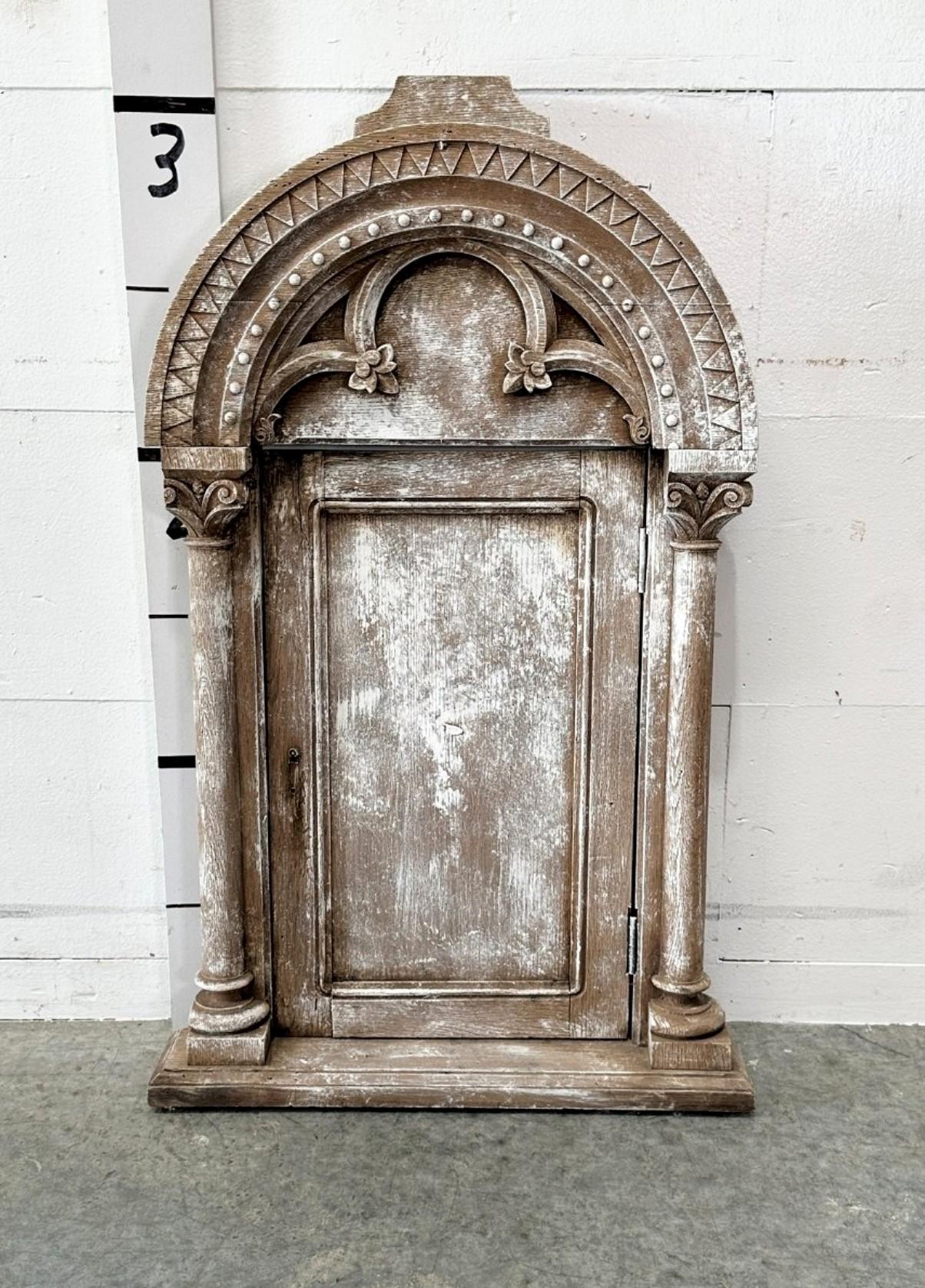 A scarce antique ecclesiastical architectural hand carved and painted wooden church - cathederal tabernacle door. 

18th century or earlier, early Medieval European Romanesque Gothic style, facade with elaborate arched header atop partial quartfoil,