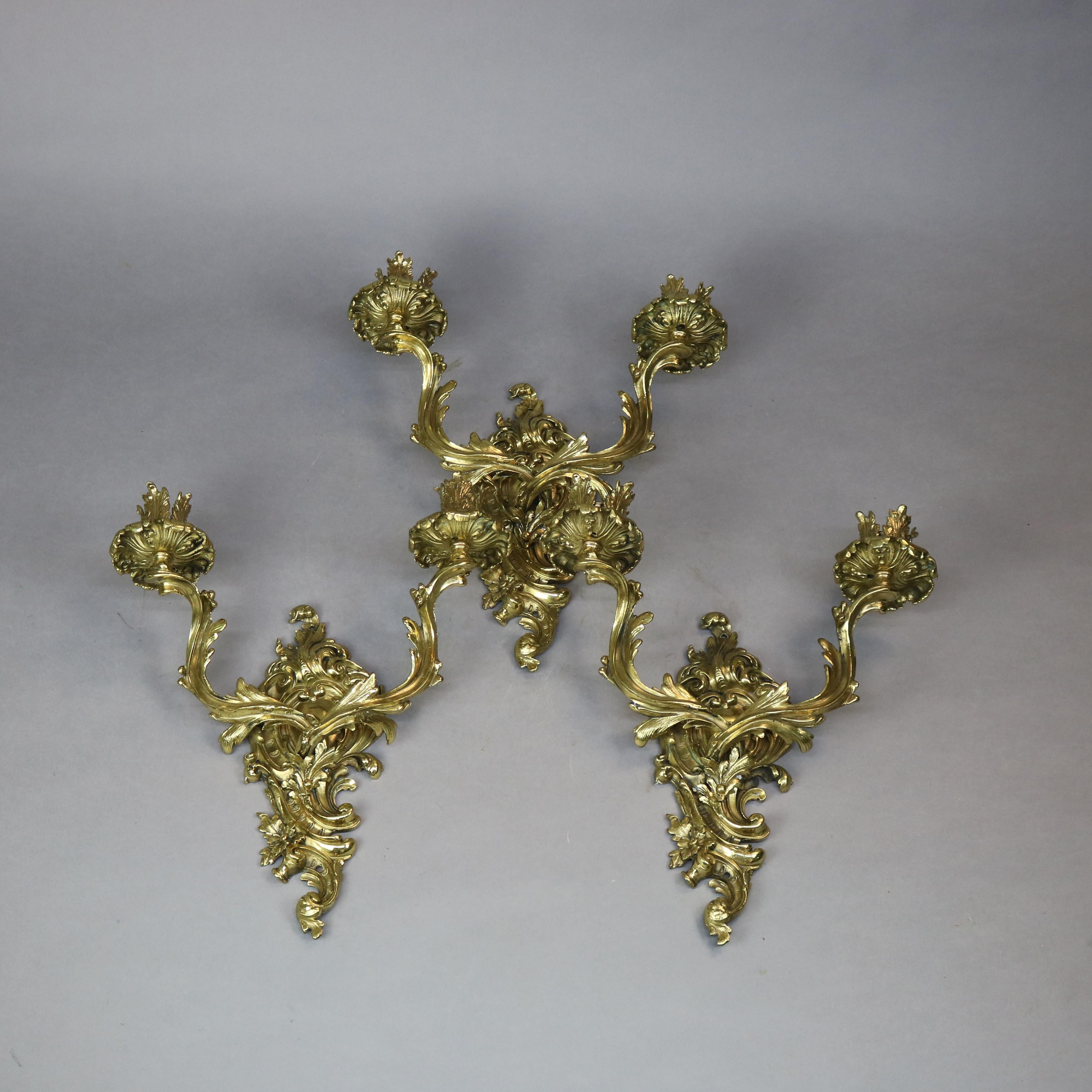An antique and early set of three French Rococo gas wall sconces offer gilt bronze castings in foliate form, each having two scroll arms terminating in candle sockets, c1870.
No label
Measures: 17