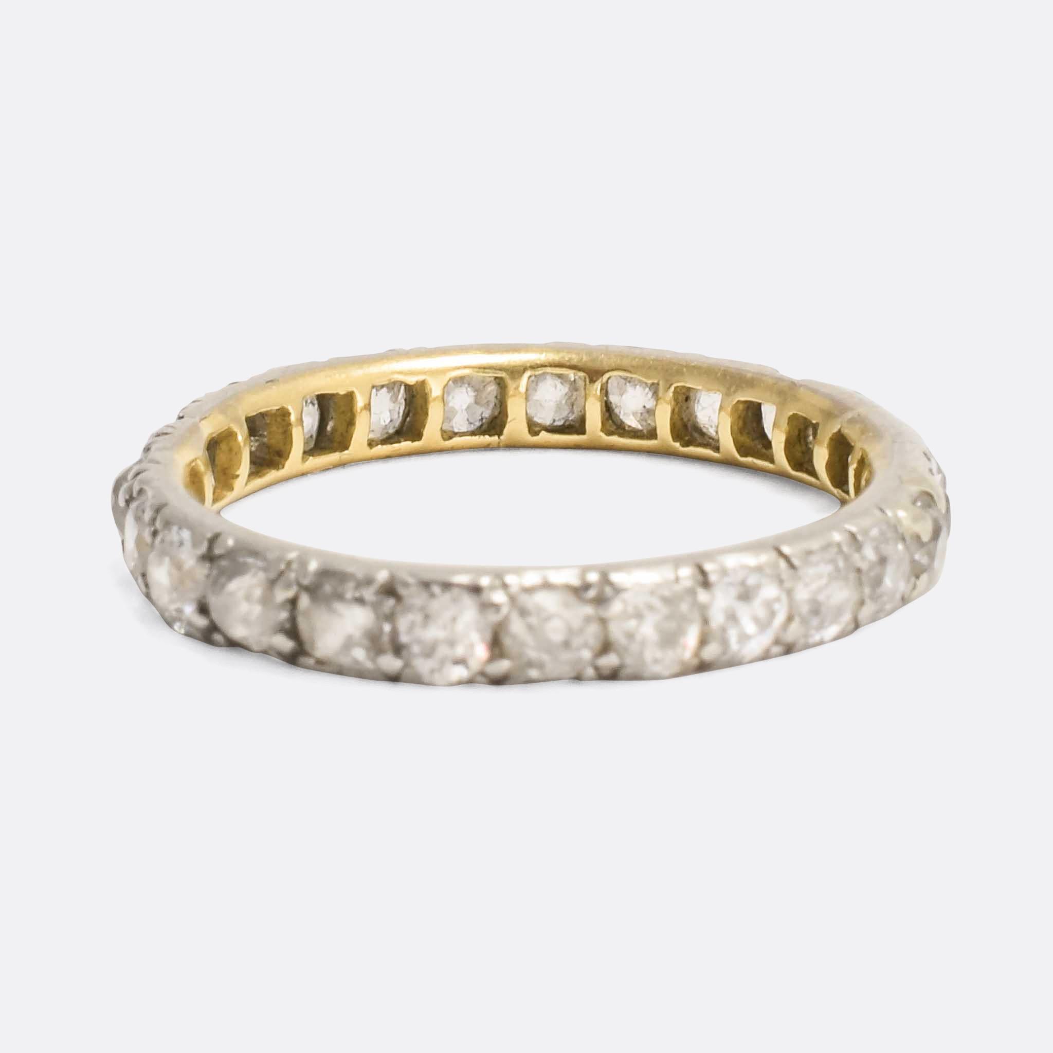 An original early Victorian diamond eternity band, fully set with old European cut stones. Mounted in silver, the 25 stones total approx. 1.25 carats. The piece dates from c.1840, with the inner band modelled in 15 karat gold. A particularly fine