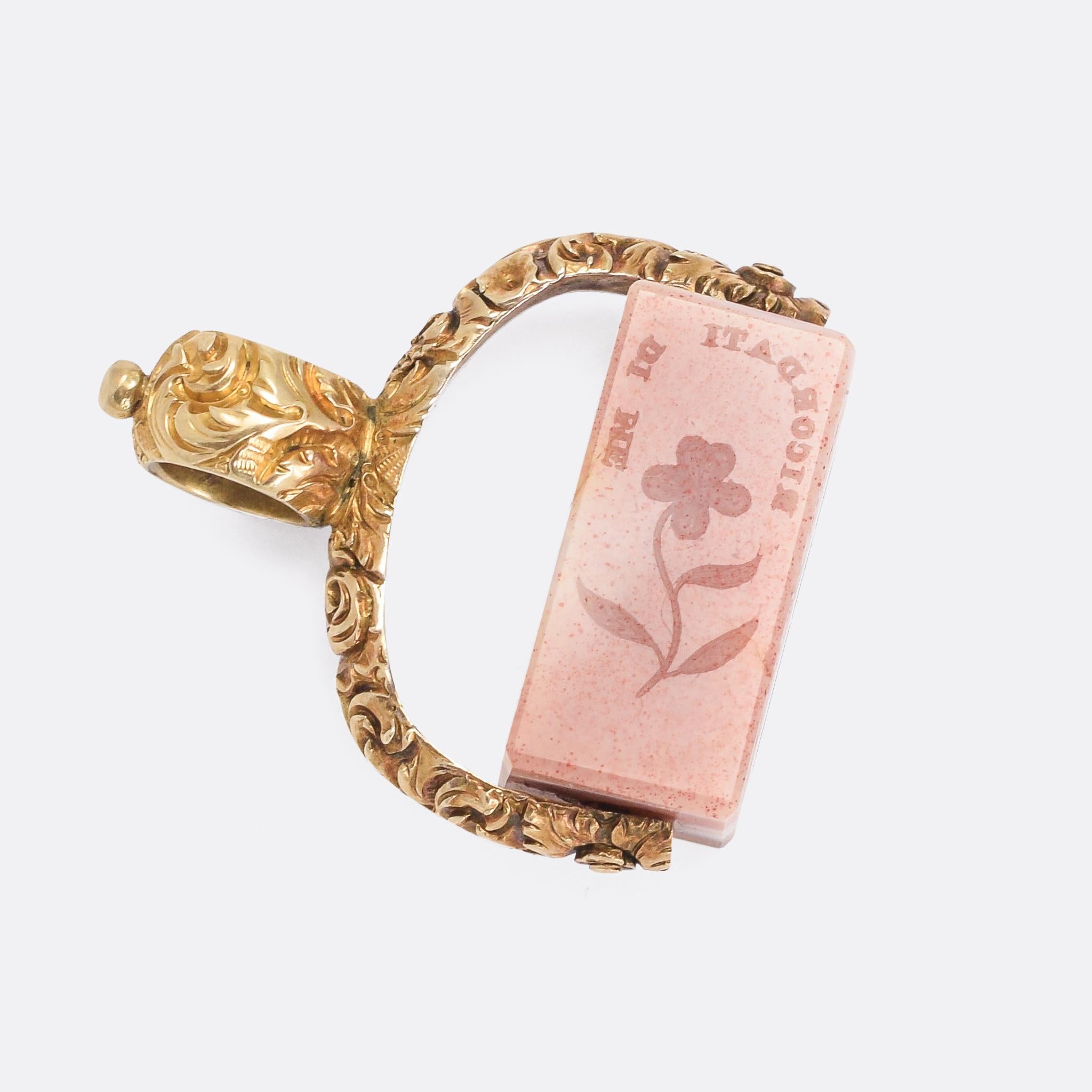 A very peculiar early Victorian spinner fob dating from the 1840s. The cuboid agate spins freely within the gold frame, and features intaglio seal carvings to each of the four faces. They include various French and Italian sentimental messages: