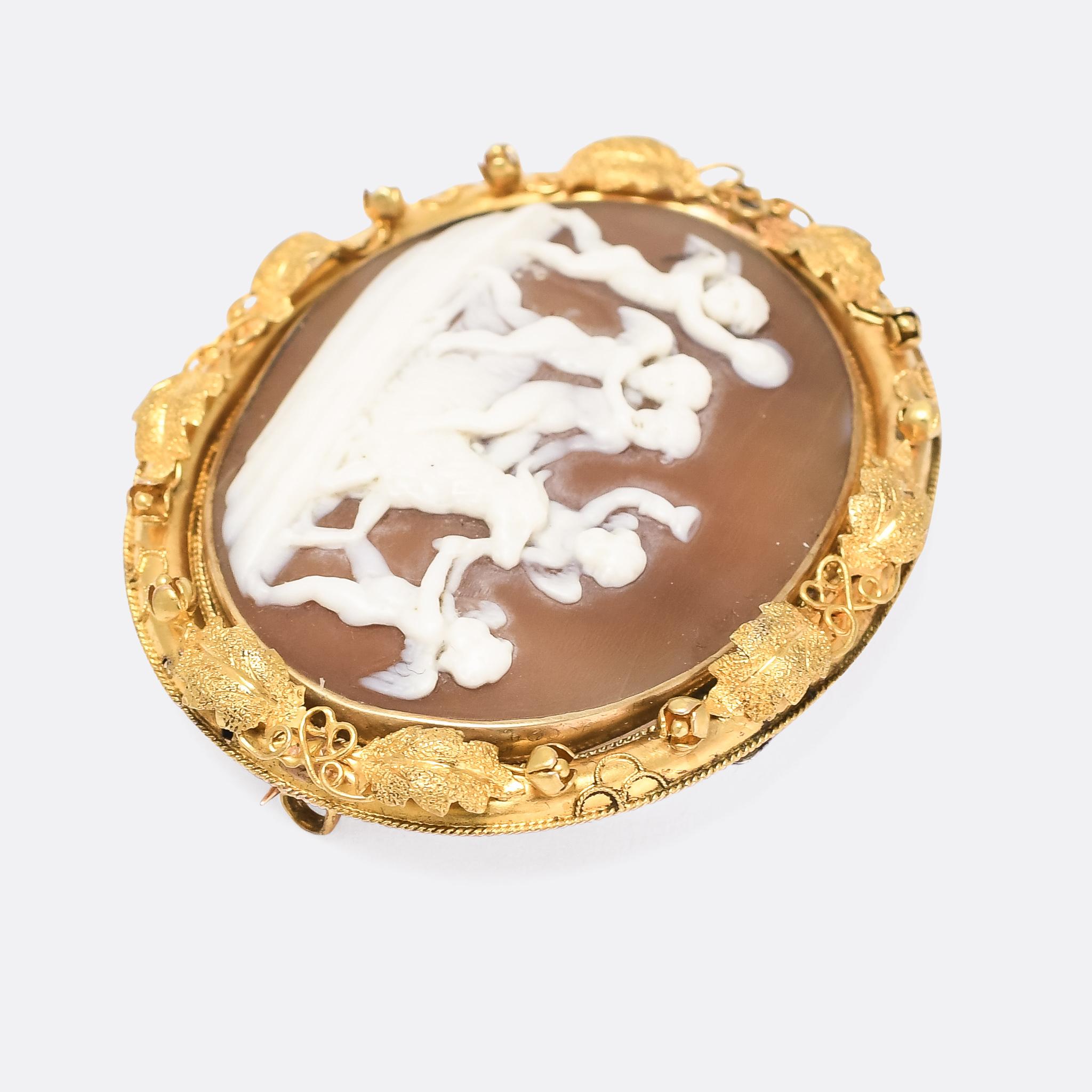 A stunning early Victorian cameo brooch depicting a bacchanal of putti, not dissimilar to the the 1620 marble relief by Flemish sculptor François Duquesnoy. The putti are seen drinking, clashing cymbals, dancing, and appearing to slaughter the goat.