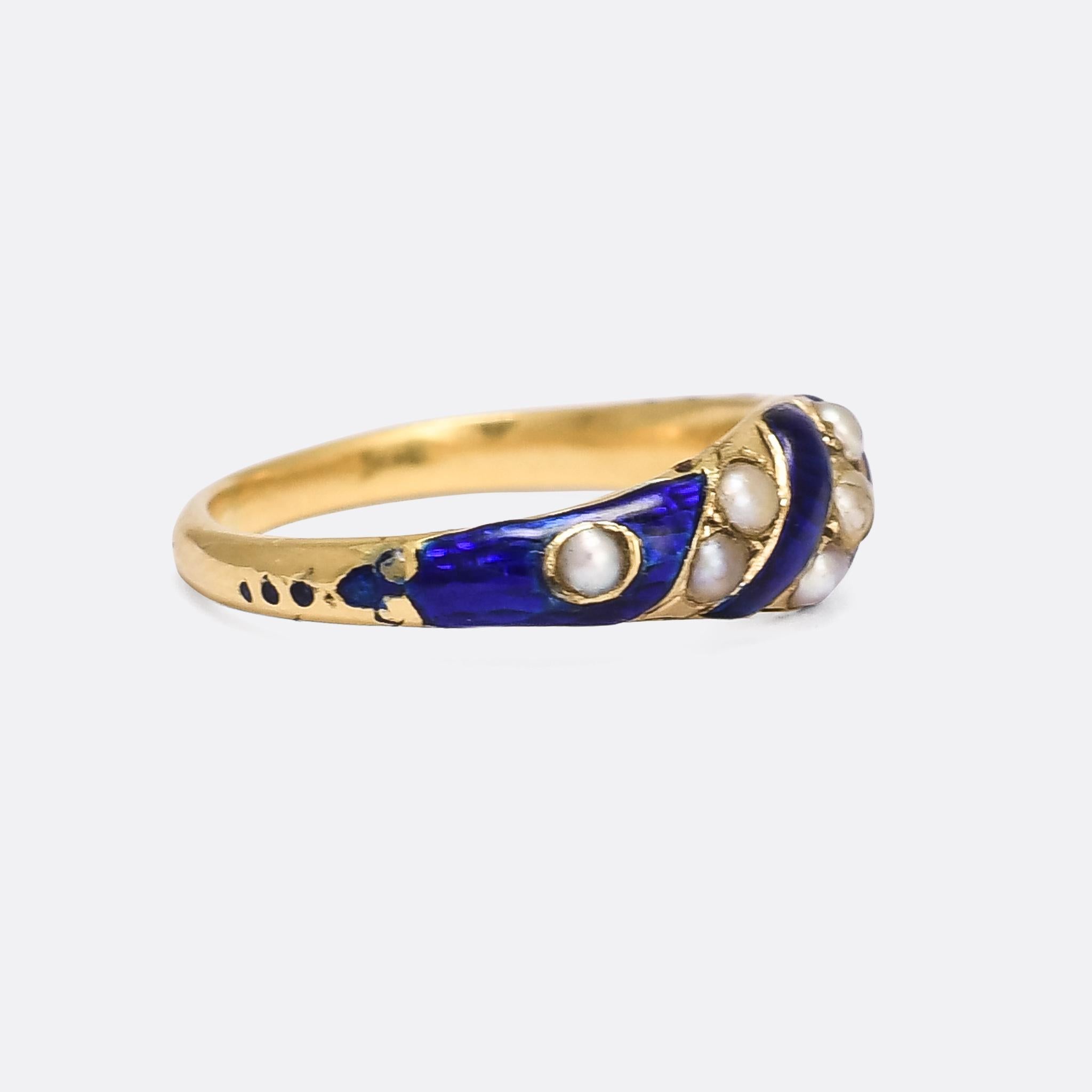 An elegant early Victorian ring set with diagonal bands of natural seed pearls alternating with vivid royal blue enamel. A secret locket compartment is concealed on the inner band behind the head, and the shoulders each feature an enamelled