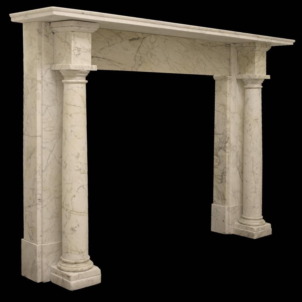 Beautifully uncomplicated early Victorian Carrara marble fire surround with freestanding Tuscan columns, terminating in block capitals.

Images prior to restoration. This chimneypiece is awaiting restoration, please enquire as to the lead time to