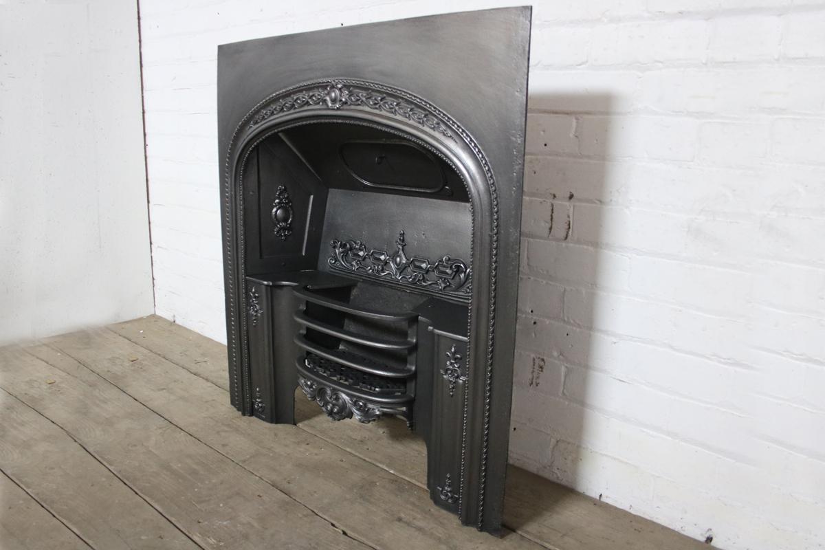 A decorative antique early Victorian cast iron hob grate by the Carron foundry, circa 1840.
Finished with traditional black grate polish and ready for a solid fuel fire.