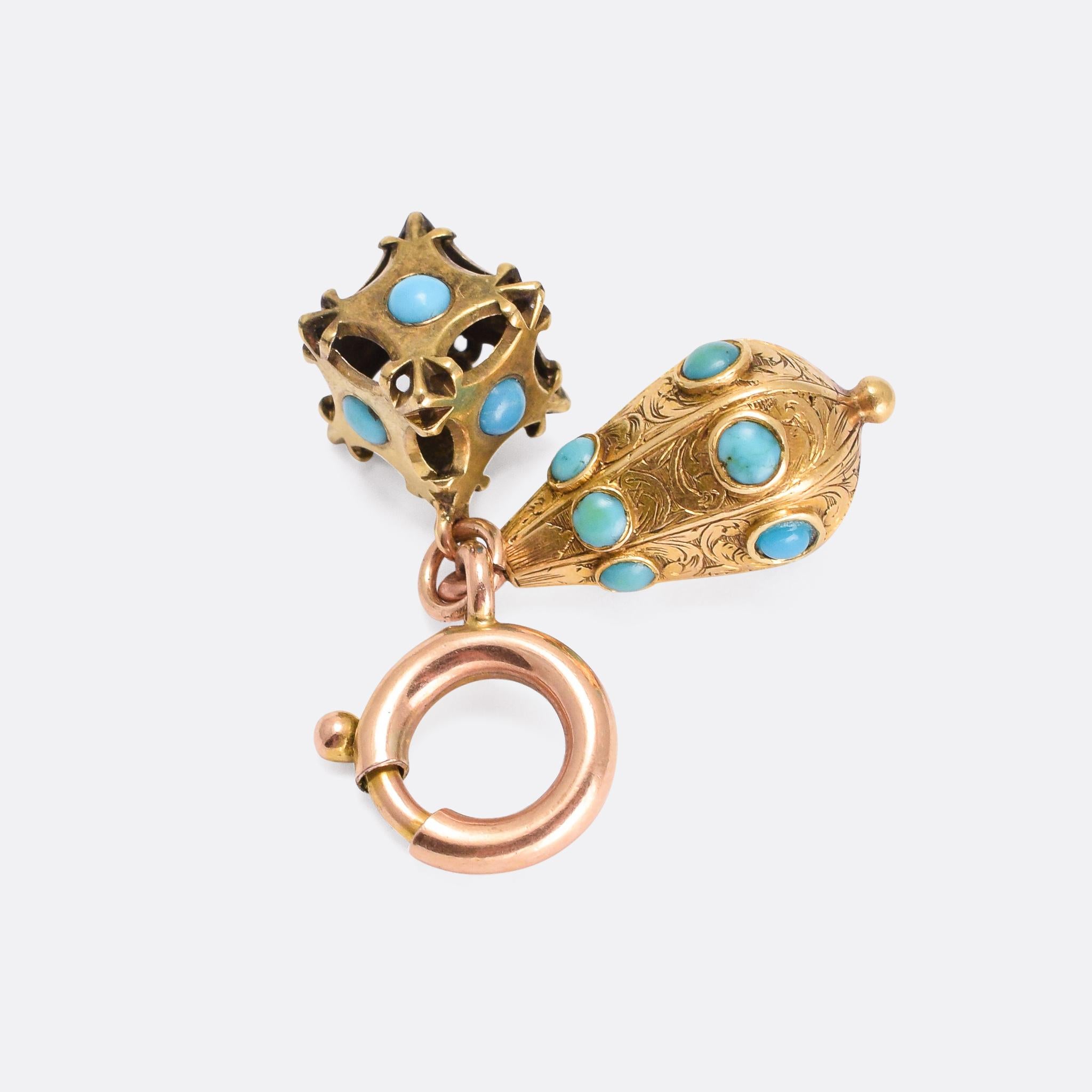 A 15k gold ring-bolt clasp paired with two early Victorian turquoise-set charms: one is an openworked cube, the other is pear shaped and features hand-chased detailing. Modelled in 15 karat gold throughout, it can be used as a charm holder or worn