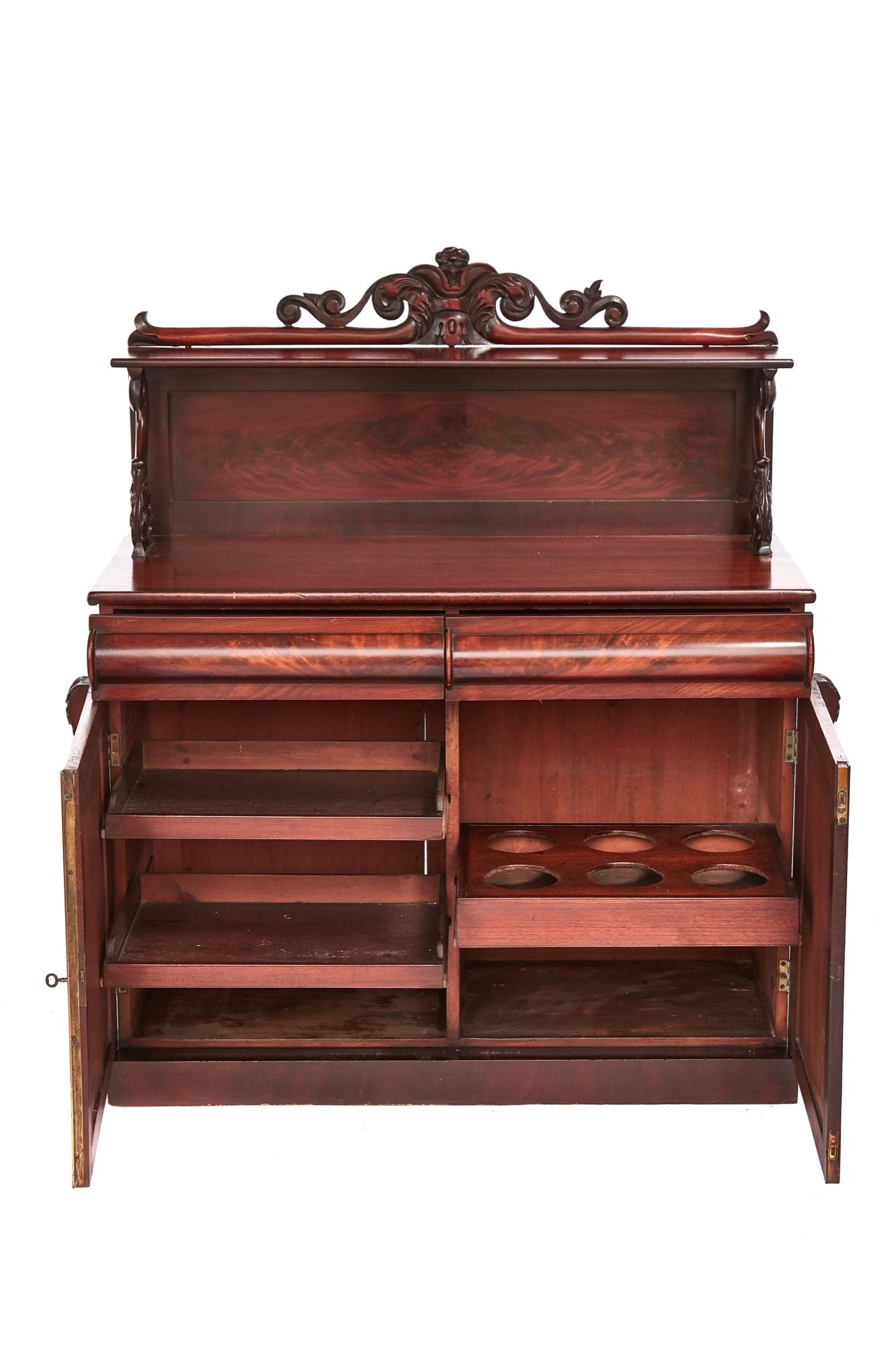 Early Victorian mahogany chiffonier with a beautifully carved back, the base boasts two frieze drawers and two mahogany doors opening to reveal a fitted interior.

In fine original condition.

  