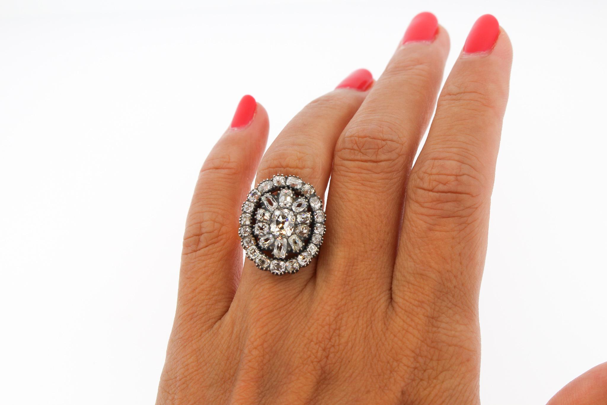 A stunning Old Mine cut diamond Victorian cluster ring, that was a button originally.  It dates to about 1850. The back is open, and not closed, showing off the lively angles of each delicately cut diamond. Each stone has high crowns, long facets,