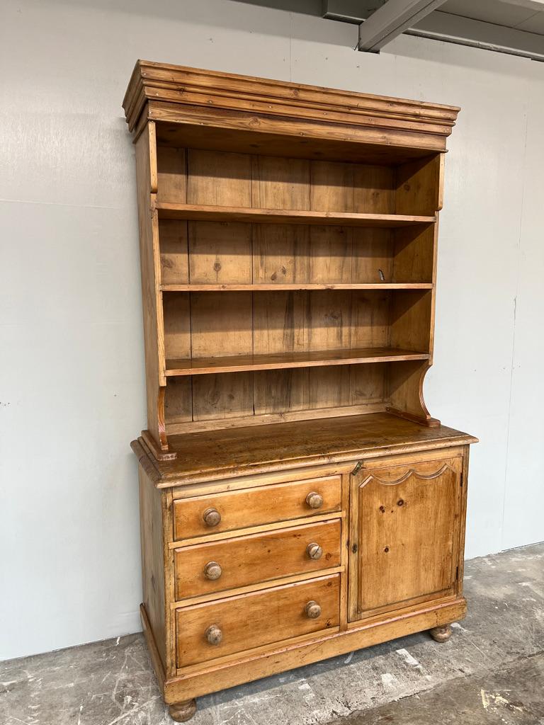 Antique Housekeeper’s Dresser with 3 drawers, cupboard and shelving space , dating from the mid 19th century. Superb original colour and patination throughout. Shaped shelving area on the one piece top. One piece top over a bank of three graduated