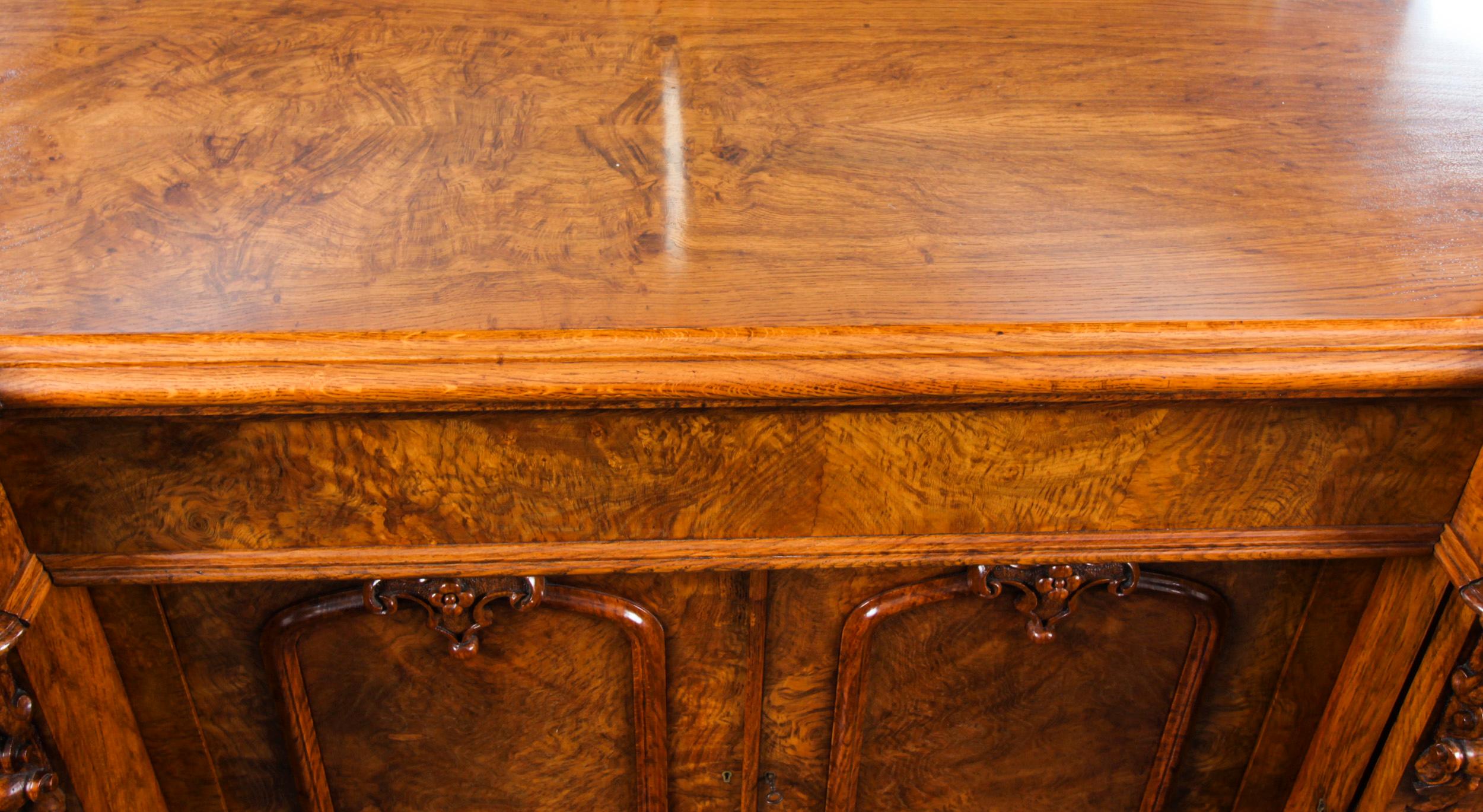 An impressive large and rear early Victorian carved pollard oak mirror back sideboard, Circa 1850 in date.

The inverse breakfront sideboard features a shaped mirror back with superbly hand carved and pierced floral cresting and corners, set above