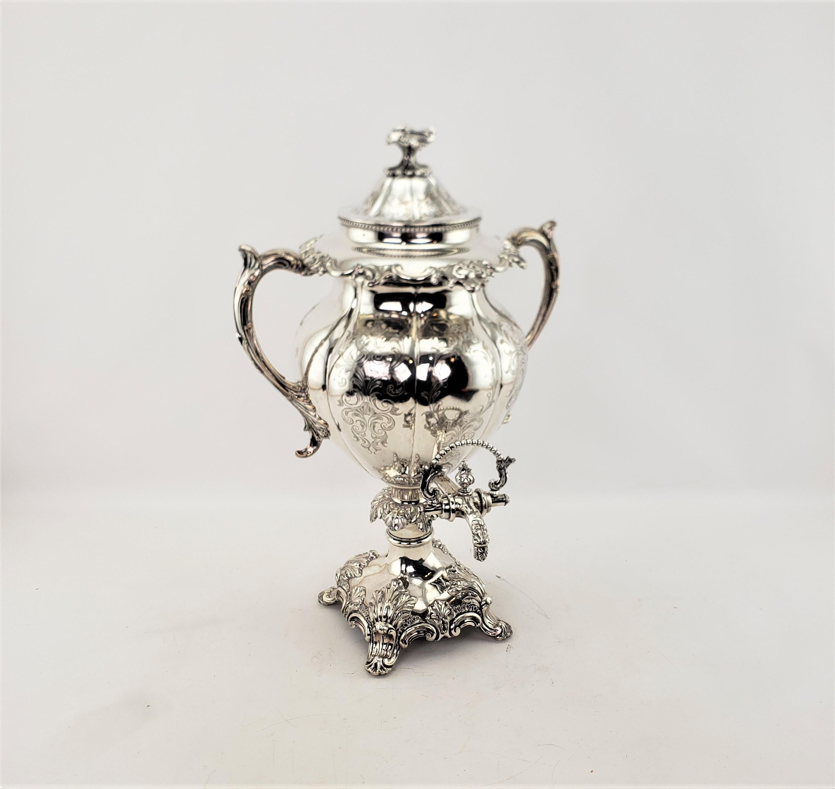 This antique hot water urn or server is unsigned, but presumed to have originated from England and date to approximately 1850 and done in the period Early Victorian style. This hot water or tea urn is composed of silver plate with a serpentine sided