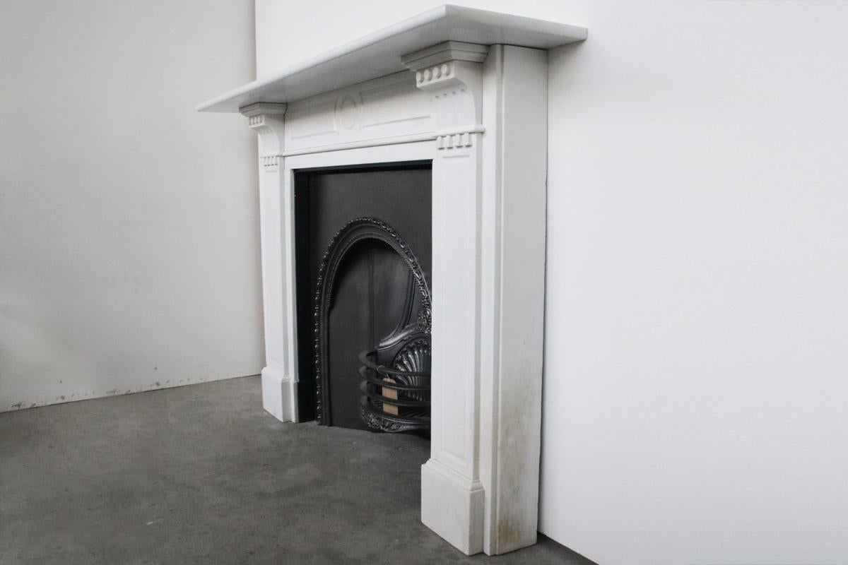 Antique early Victorian statuary white marble fire surround with fluted panels to the legs and frieze and carved corbels supporting the bull-nosed moulded shelf.


Slight discoloration to the outside lower right leg which is shown in the photos.
