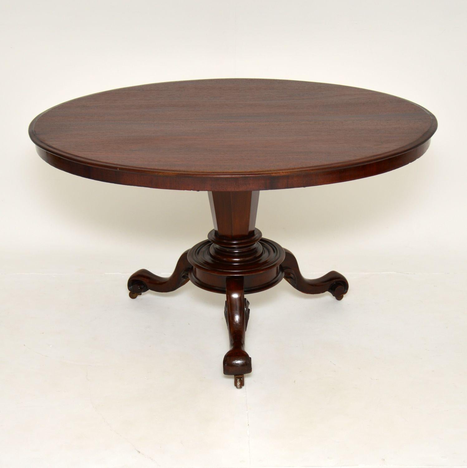A beautiful and unusual antique early Victorian period tilt top table. This was made in England, it dates from around the 1840-1860’s.

It has a lovely solid woo oval top and sits on a finely carved tripod base with a central octagonal column.