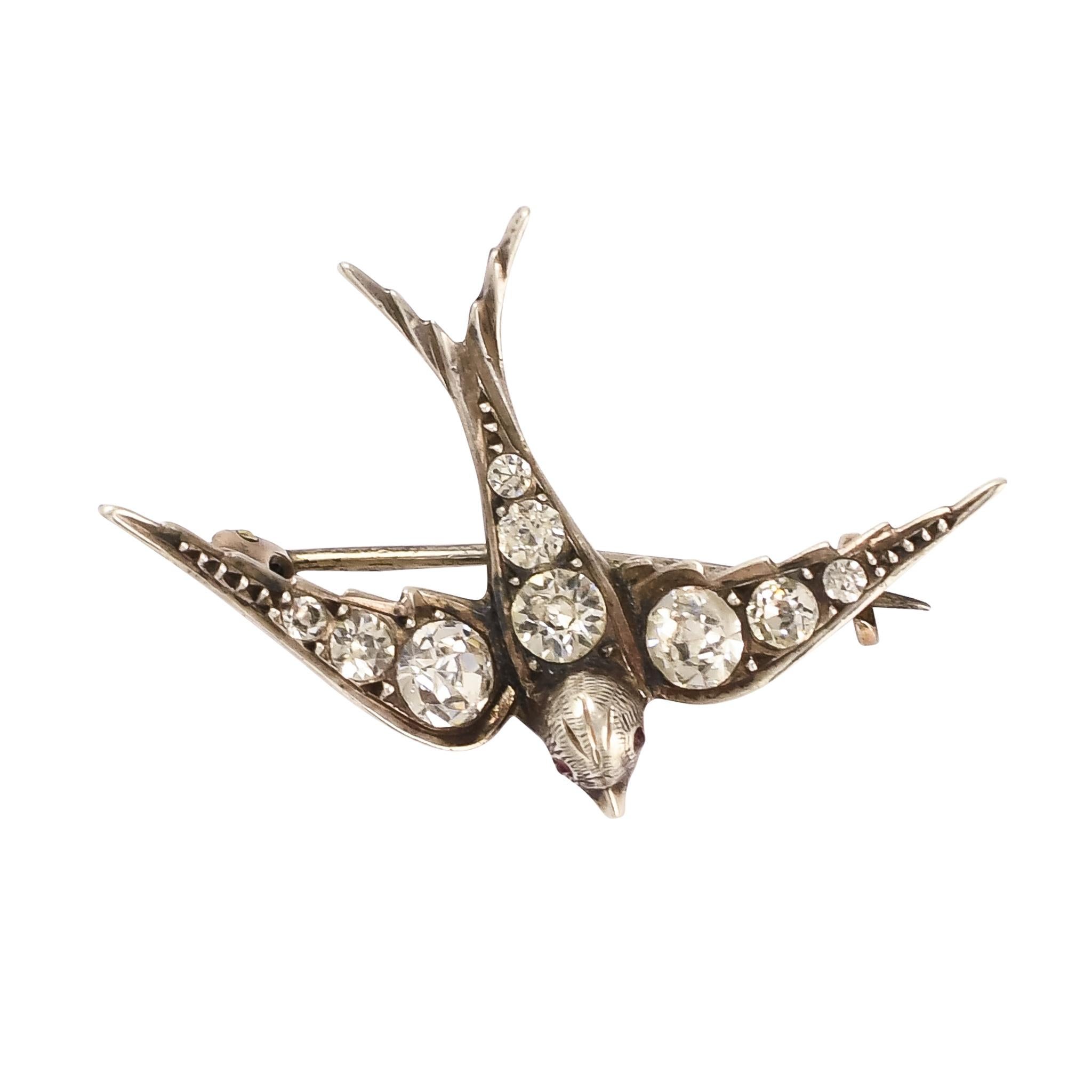 A beautiful early Victorian diving swallow brooch set with bright white paste gemstones. The sterling silver has oxidised around the stones, creating the most gorgeous patina, and also enhancing the appearance of the pastes through increased