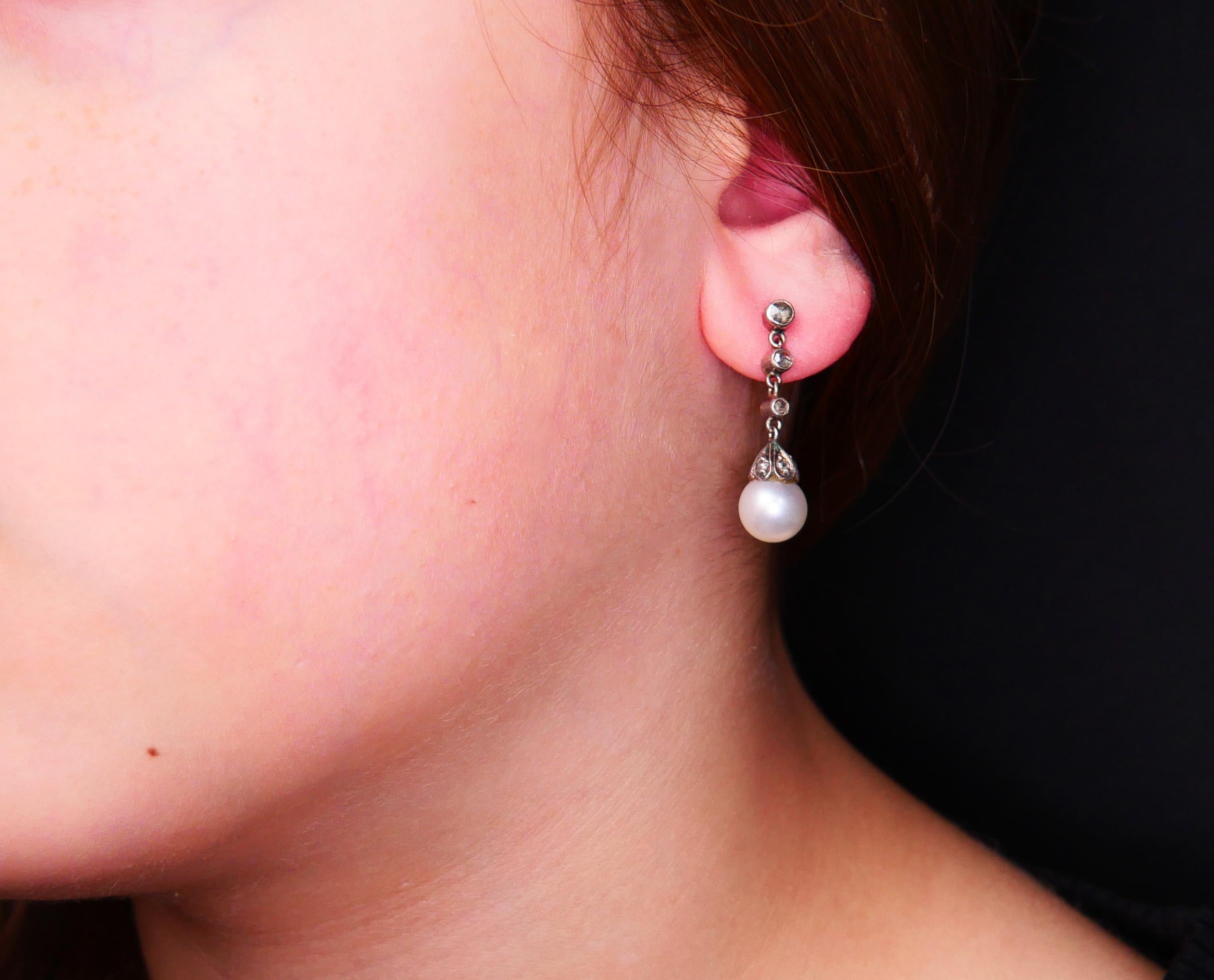 A pair of antique European hand - made ca 1920s - 1930s Silver on 18K Rose Gold flexible pendant earrings featuring cultured pearls Ø7.5 mm each and rose cut Diamonds .

Flexible links, six bezel set larger diamonds of gradual diameters Ø 2 /0.03ct,