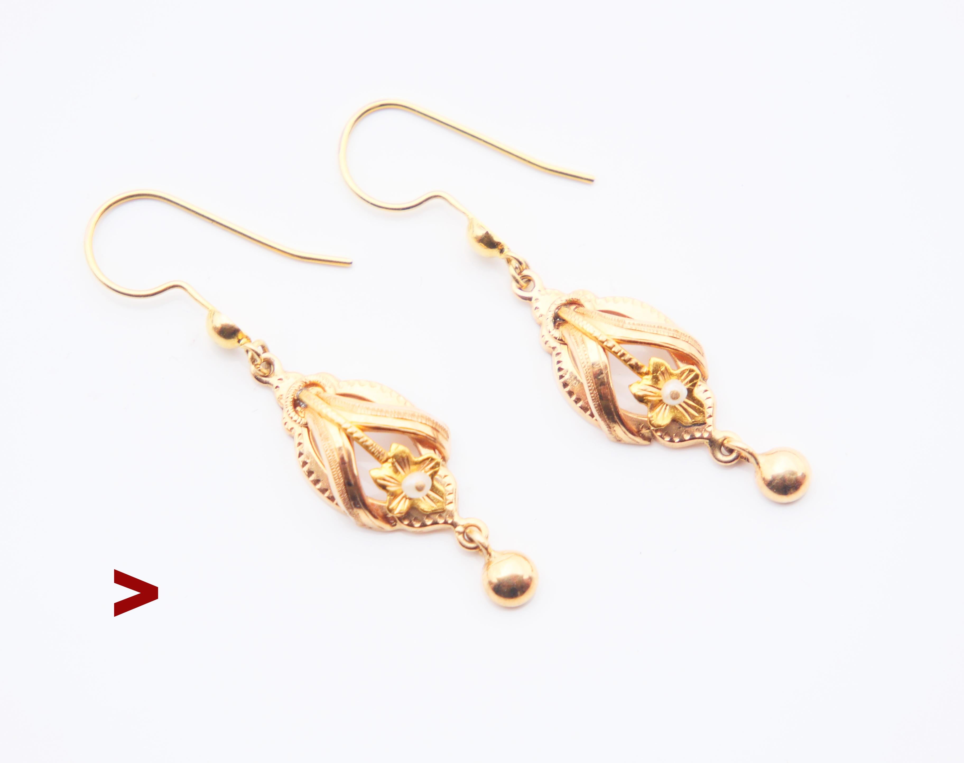 A pair of antique dangle earrings  decorated with delicate engraved ornaments and pierced Seed Pearls.

No hallmarks, metal tested solid 18K Gold. European. hand- made ca 1920s-1930s.

Each earring is 34 mm long suspended x 4.5 mm deep. Each Pearl Ø