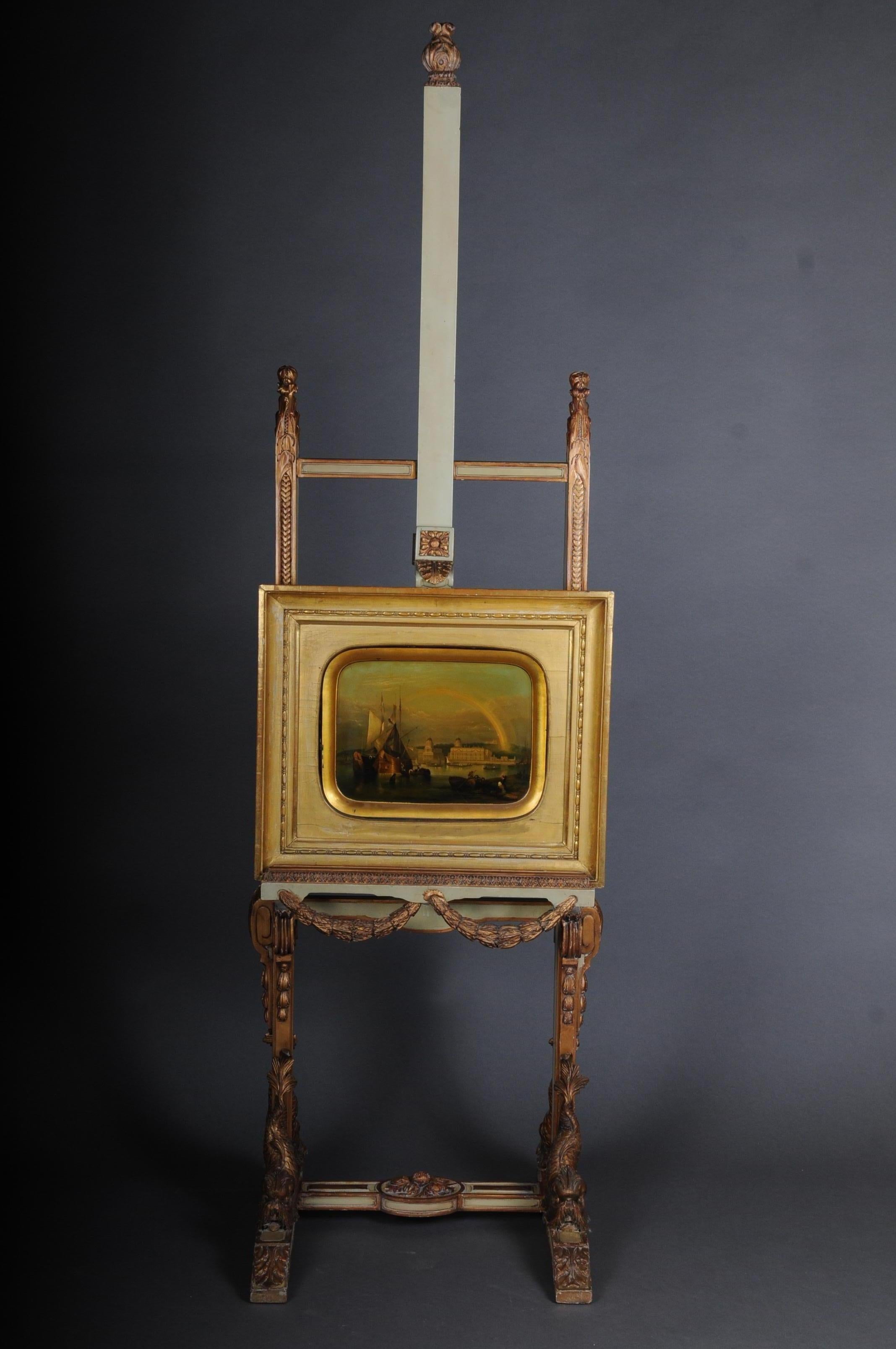 Antique easel with dolphins in Napoleon III, circa 1870

Solid beechwood body, hand carved. Richly ornamented and with 4 fully plastic, hand carved dolphins. Colored and gilded with poliment. Height-adjustable device up to a height of approximate