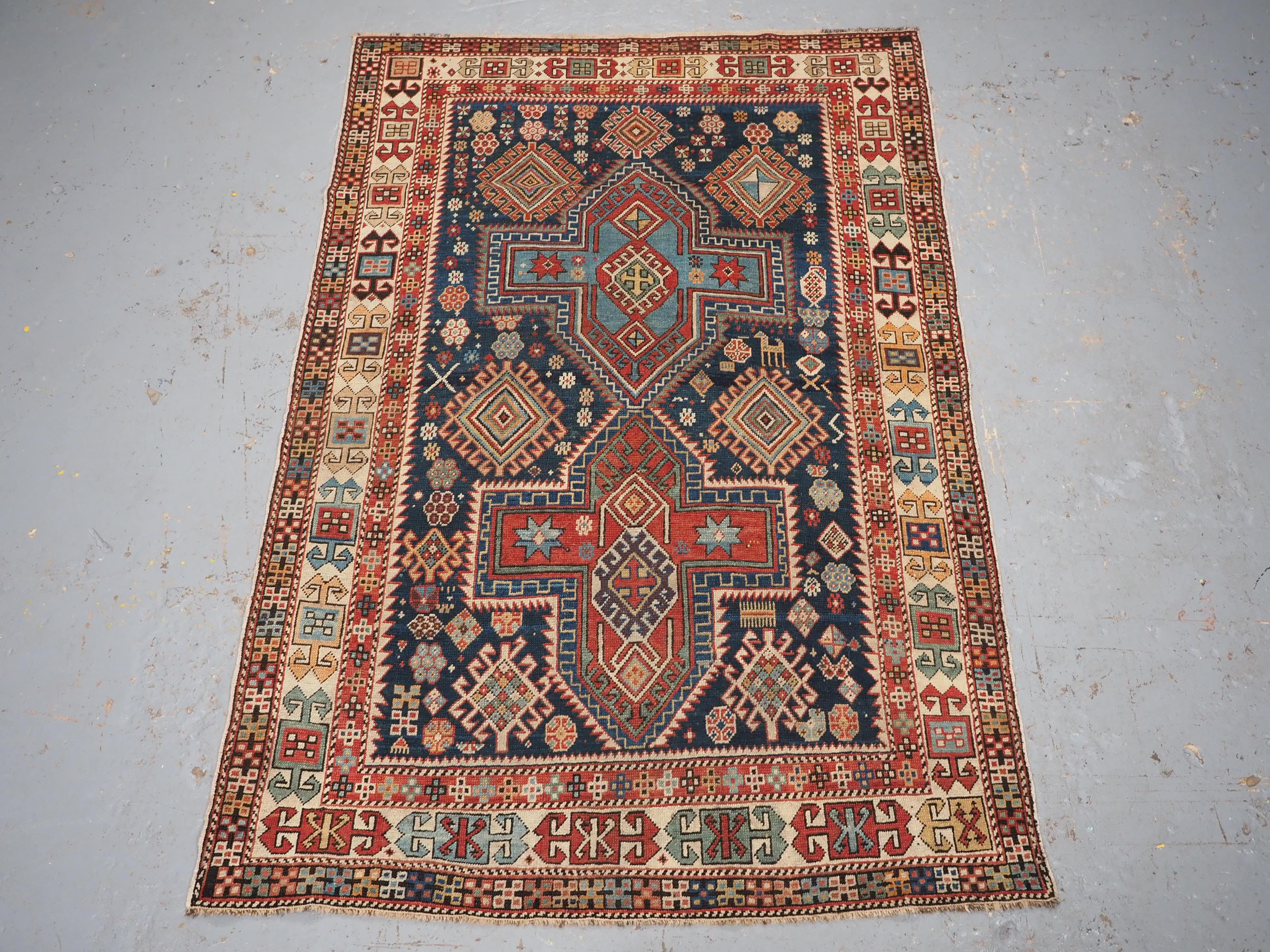 
Size: 5ft 11in x 4ft 0in (180 x 122cm).

Antique East Caucasian Akstafa rug with twin medallions.

Circa 1890.

A good small rug with two cruciform medallions on a dark indigo blue ground. The medallions in light indigo blue and madder red are