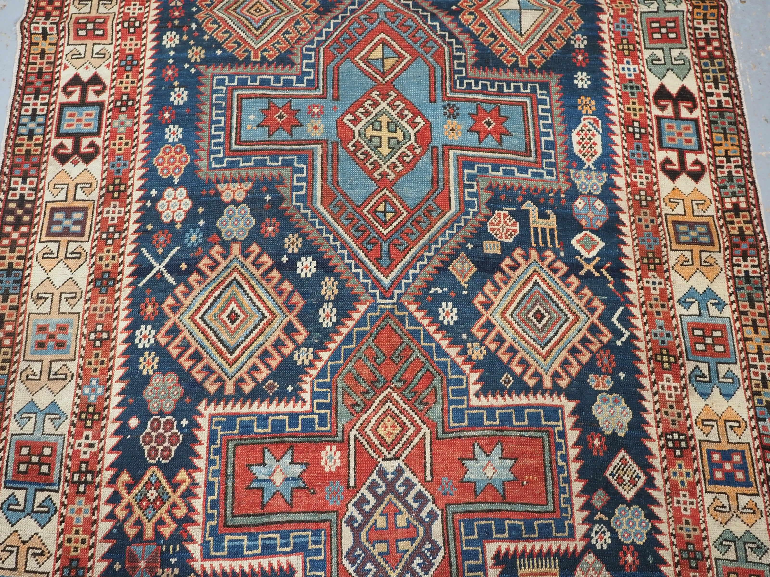 Wool Antique East Caucasian Akstafa rug with twin medallions.  Circa 1890. For Sale