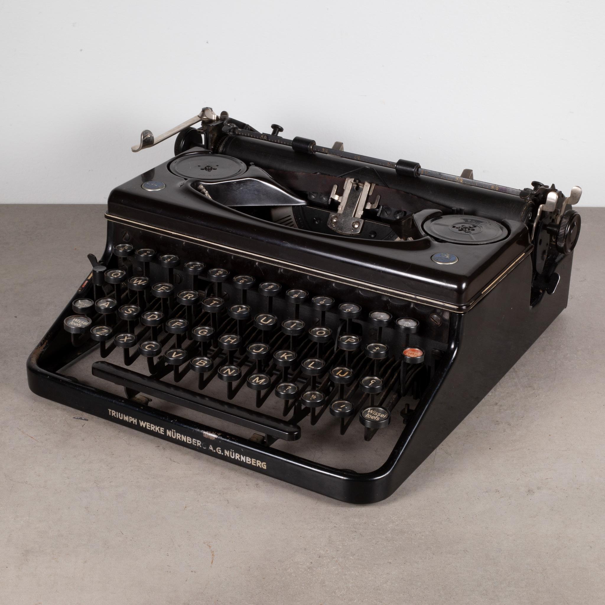About

An antique Antique East German Triumph Werke A.G. Nurnberg typewriter with German keys. Two medallions on top 